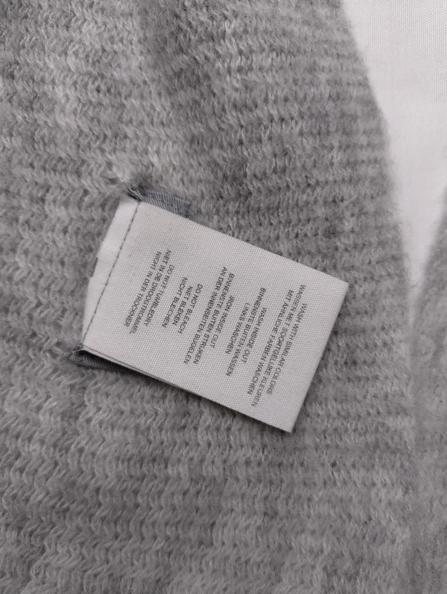 View of scarf's label and fabric texture
