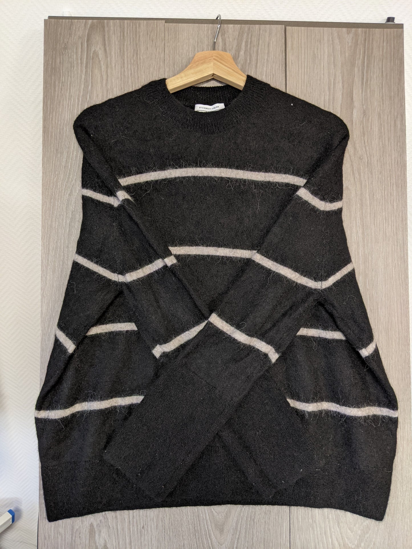 Side view of a black striped sweater