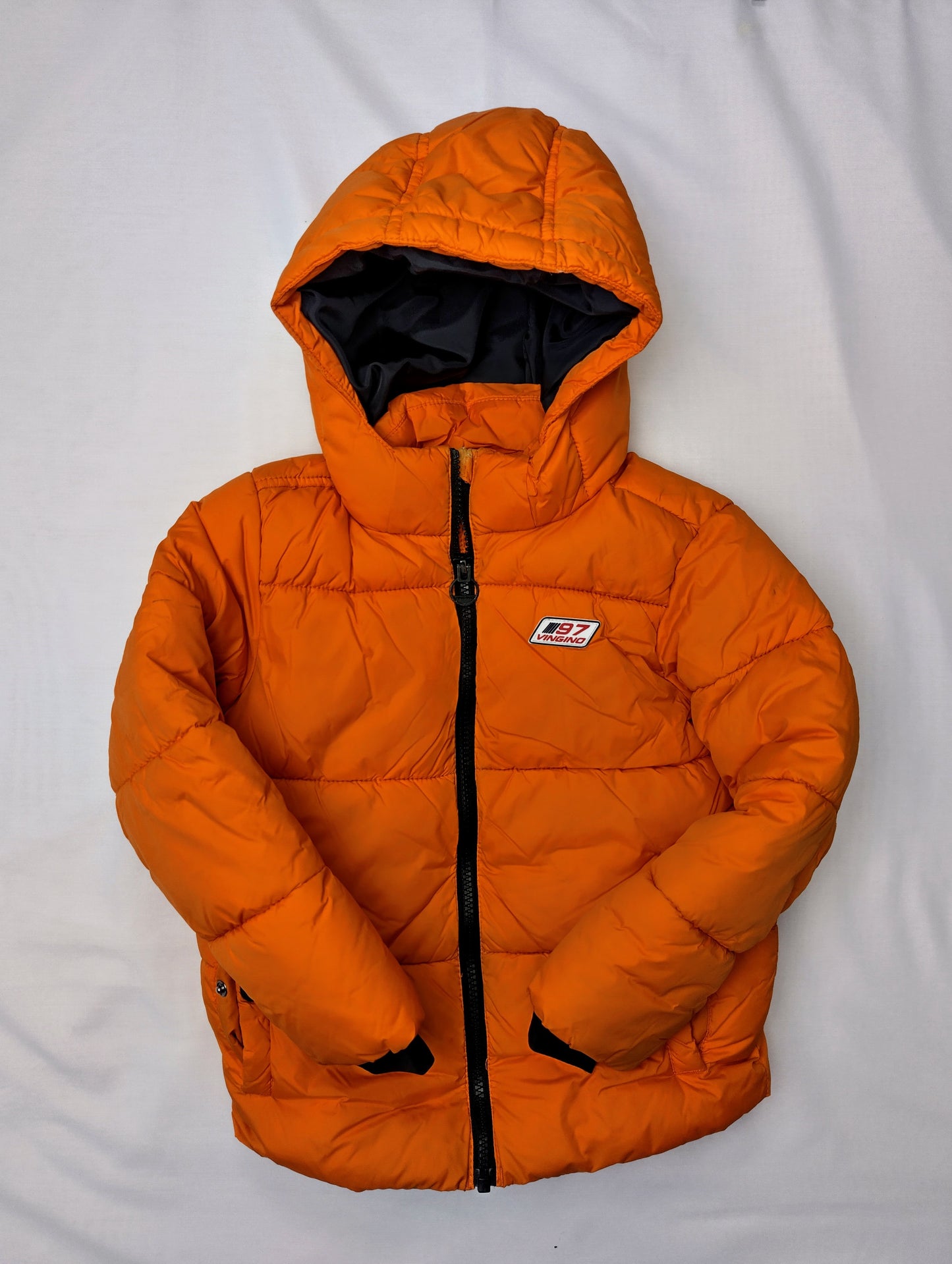 Front view of puffer jacket with hands folded