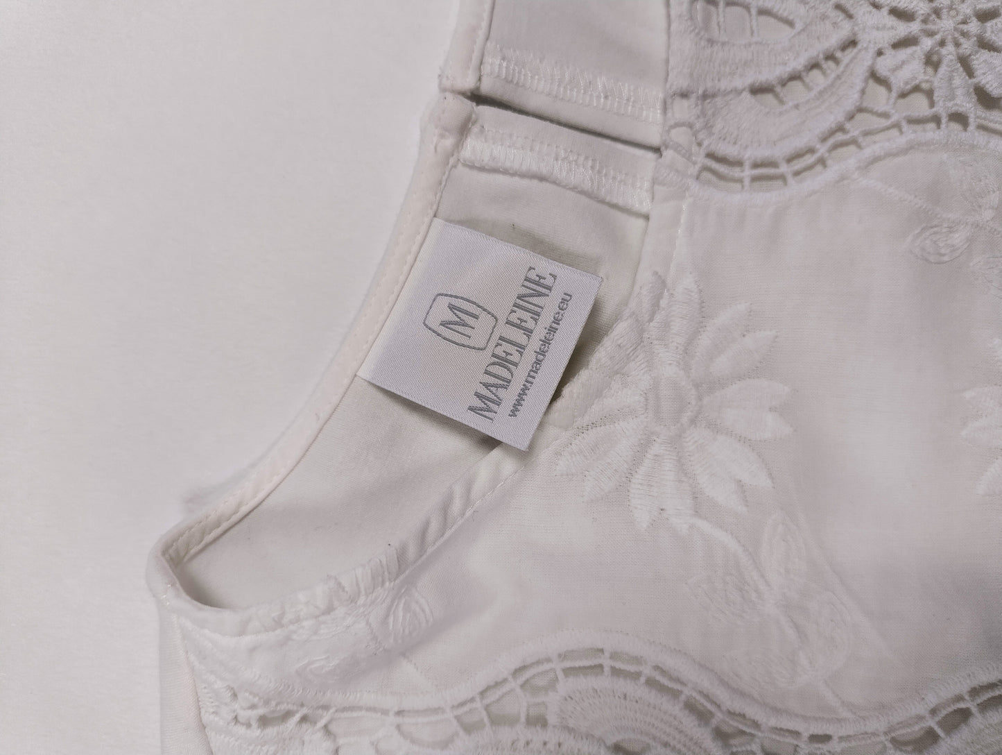Close-up of the tag on the white blouse
