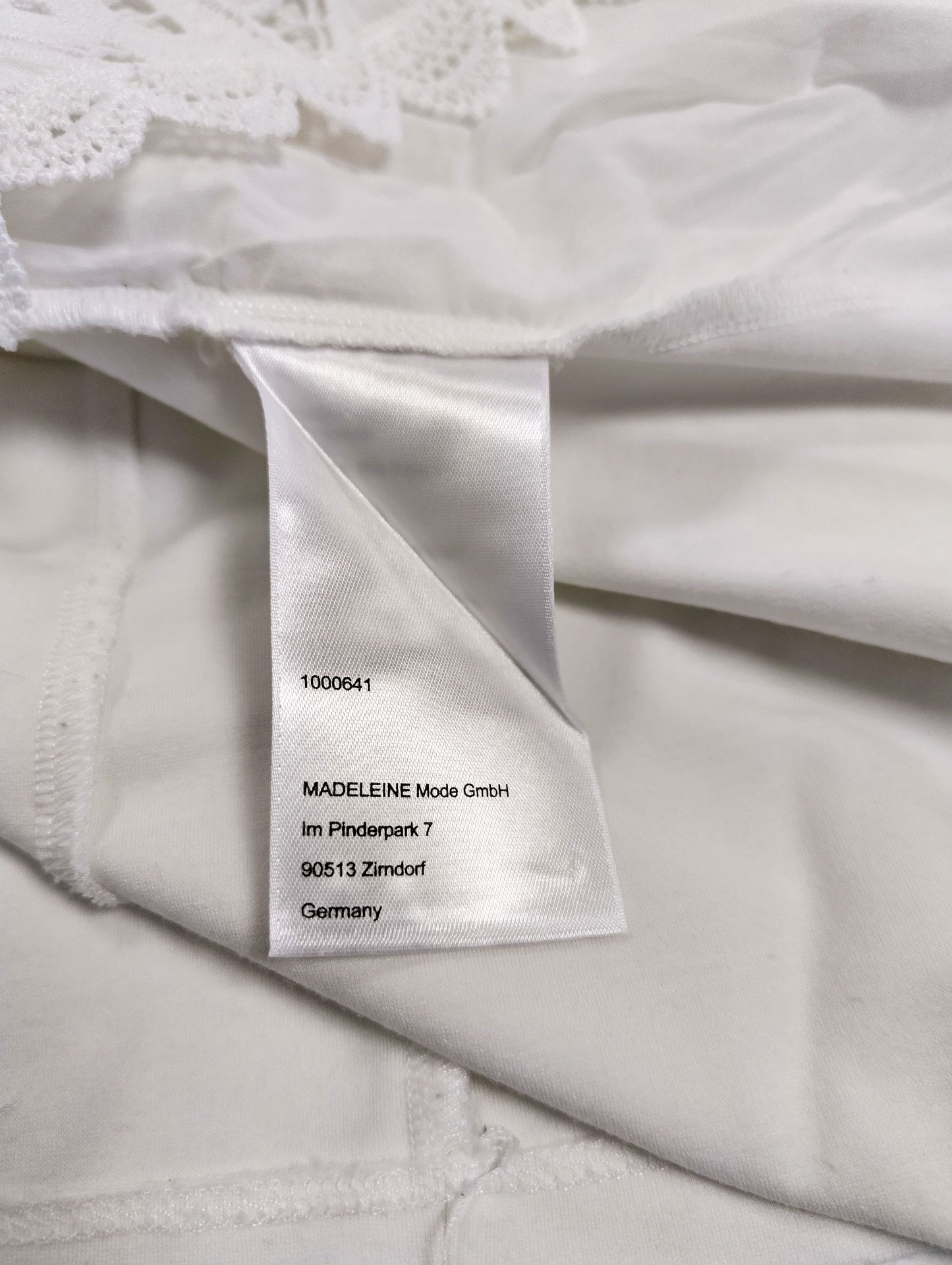 Close-up of the care label on the white blouse