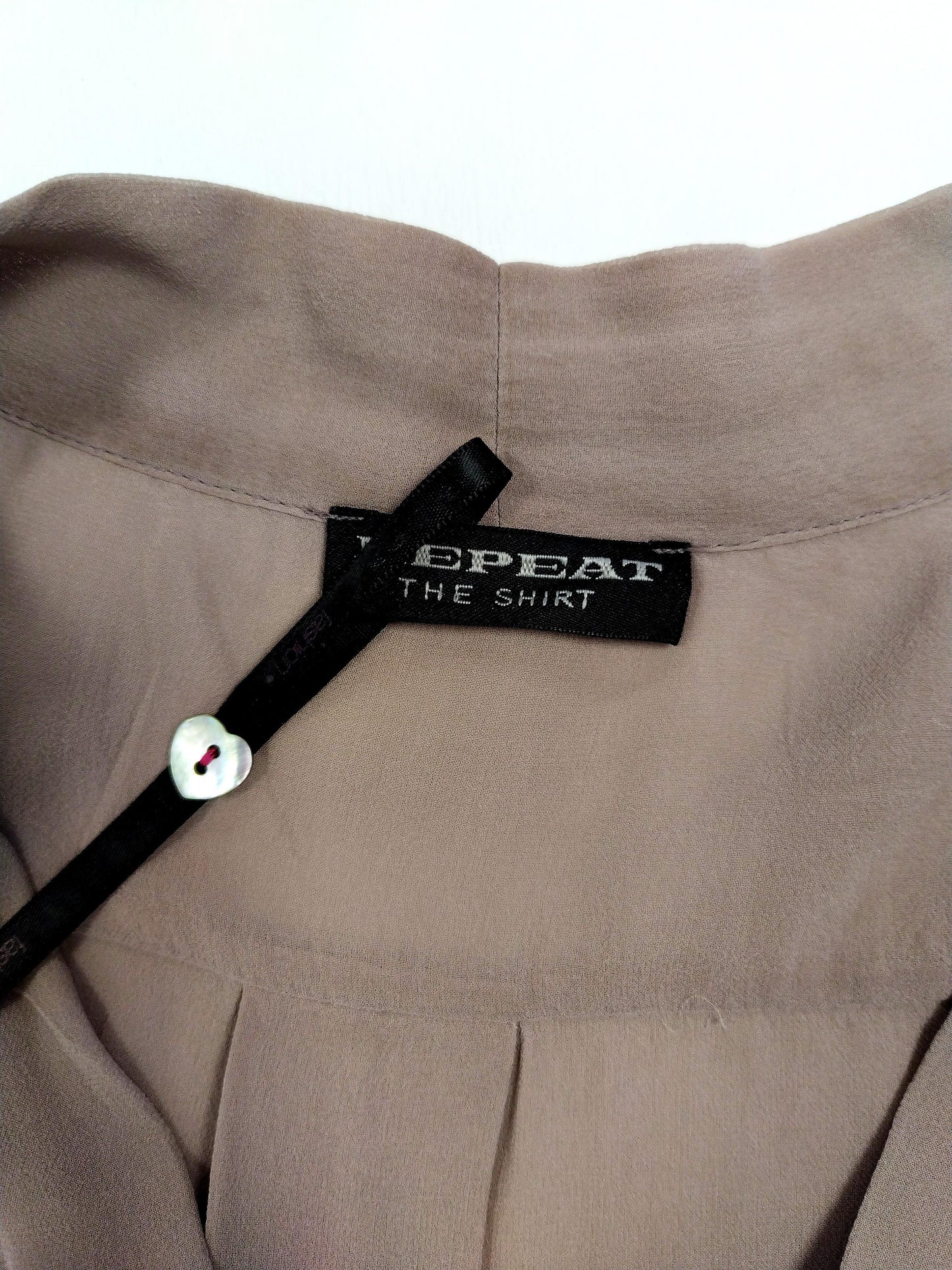 Close-up of blouse neckline and tag