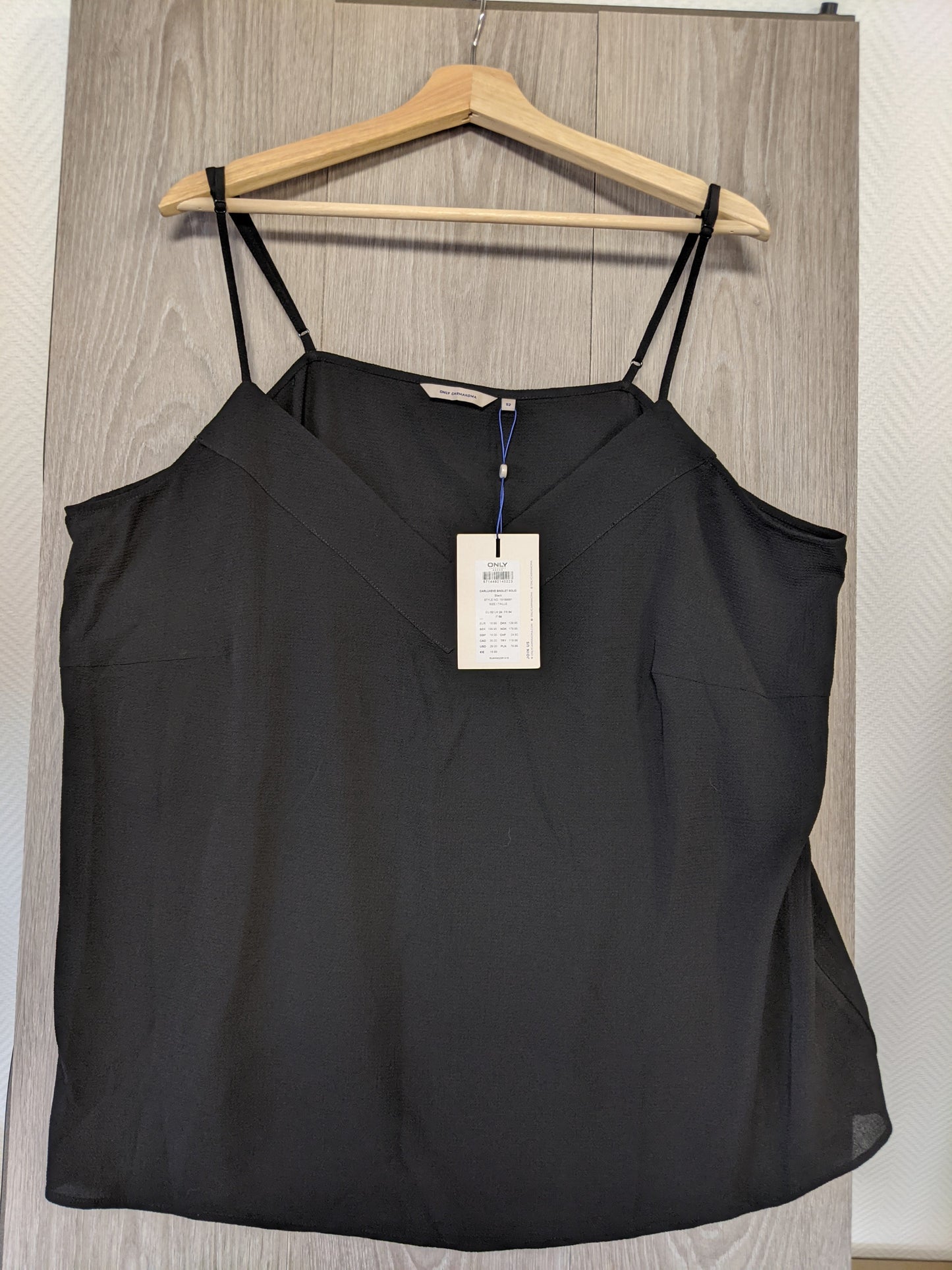 Black camisole top on hanger