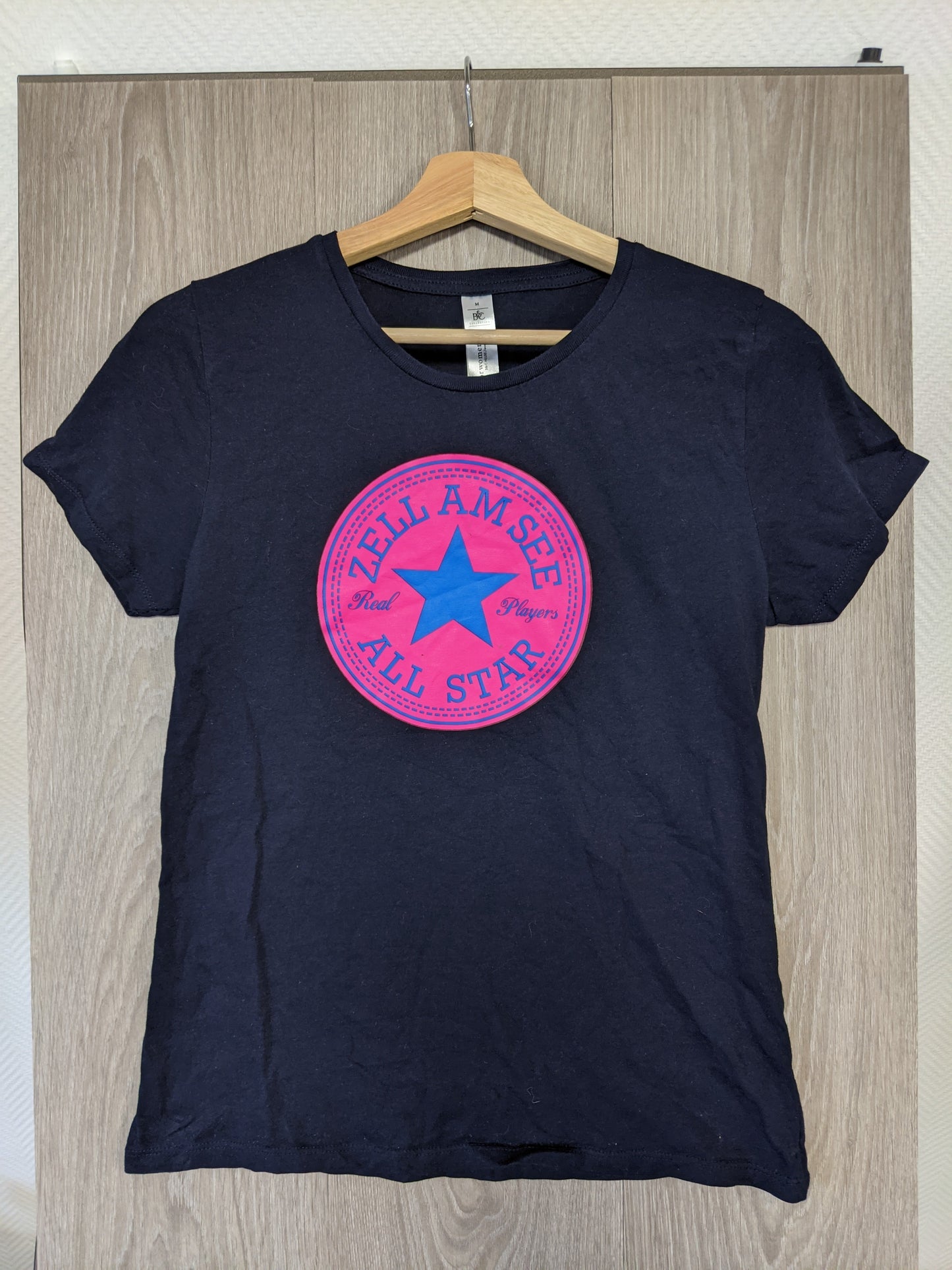 Front view of the black t-shirt with a colorful graphic