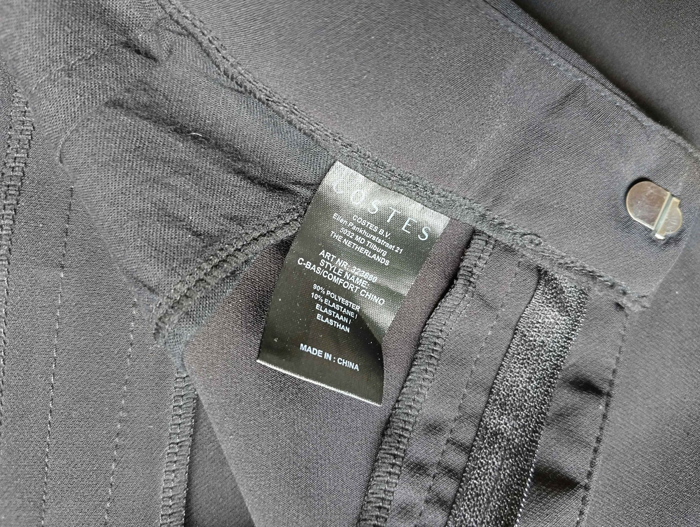 Label showing details of Costes black chinos