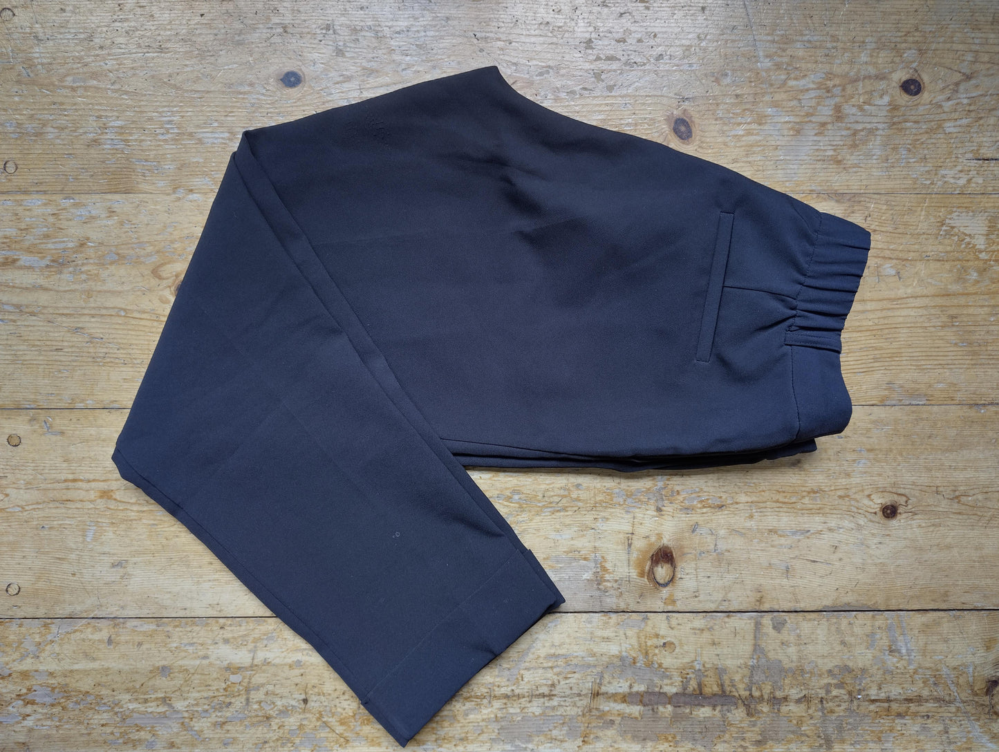 Folded black Costes chinos displaying back pocket