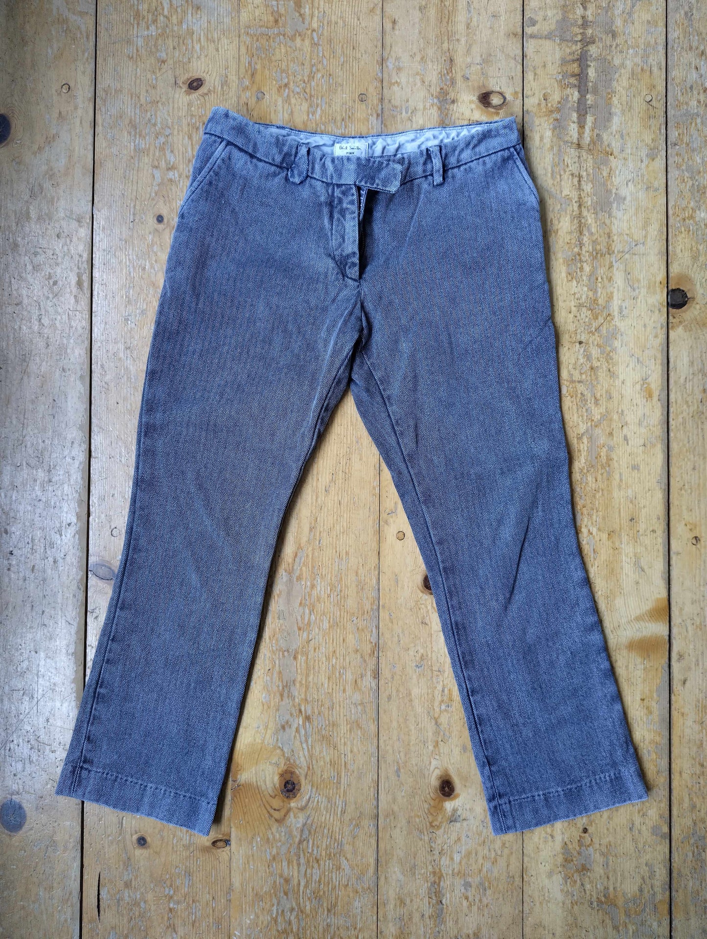 Front view of blue trousers on a wooden floor