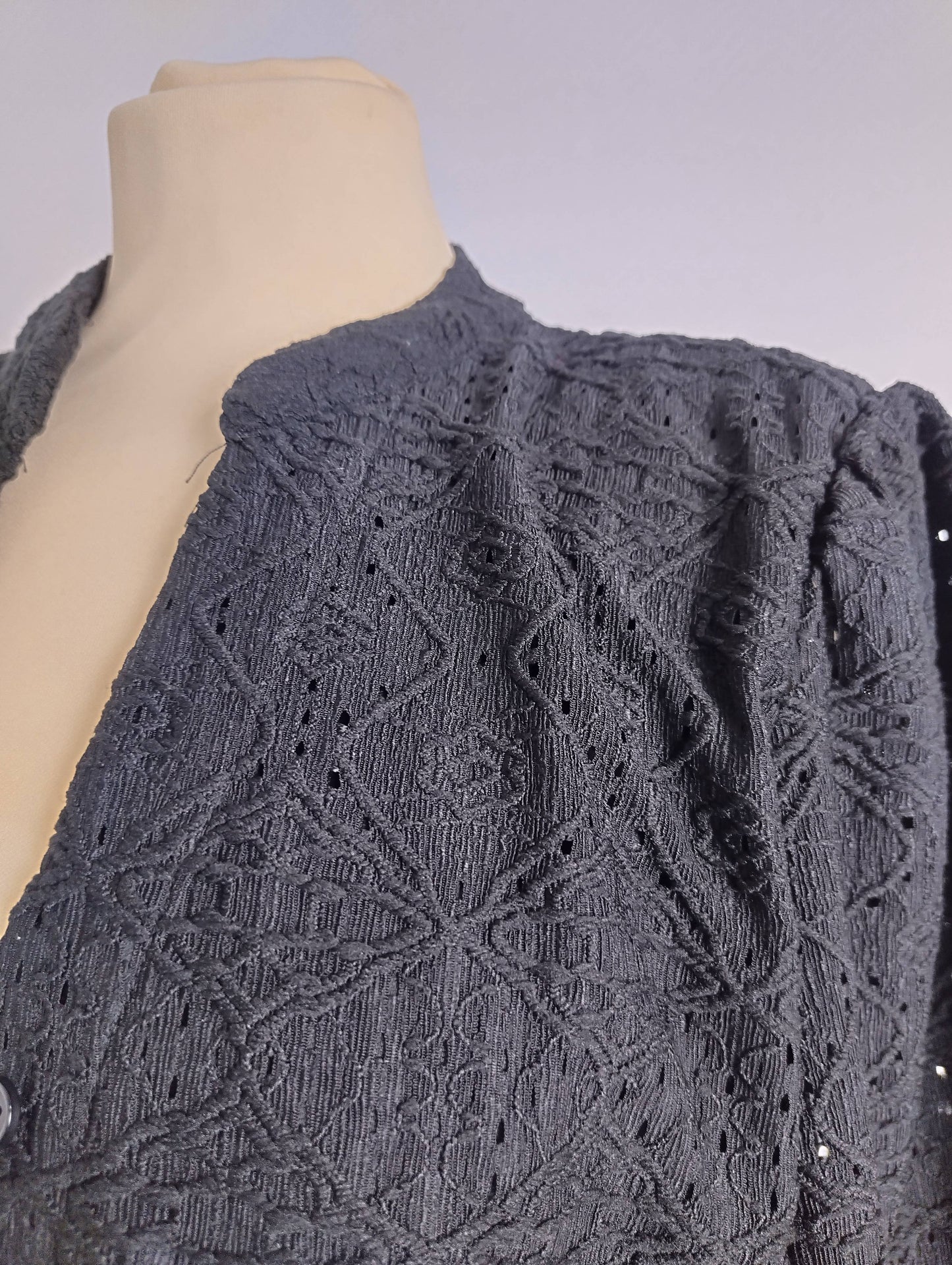 Close-up of embroidered detail on shirt