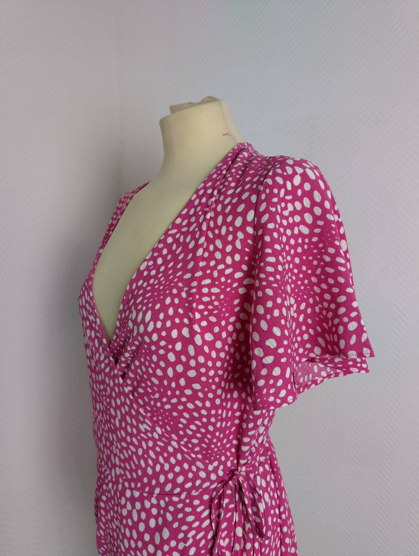 Side view close-up of pink polka dot wrap dress by Vila