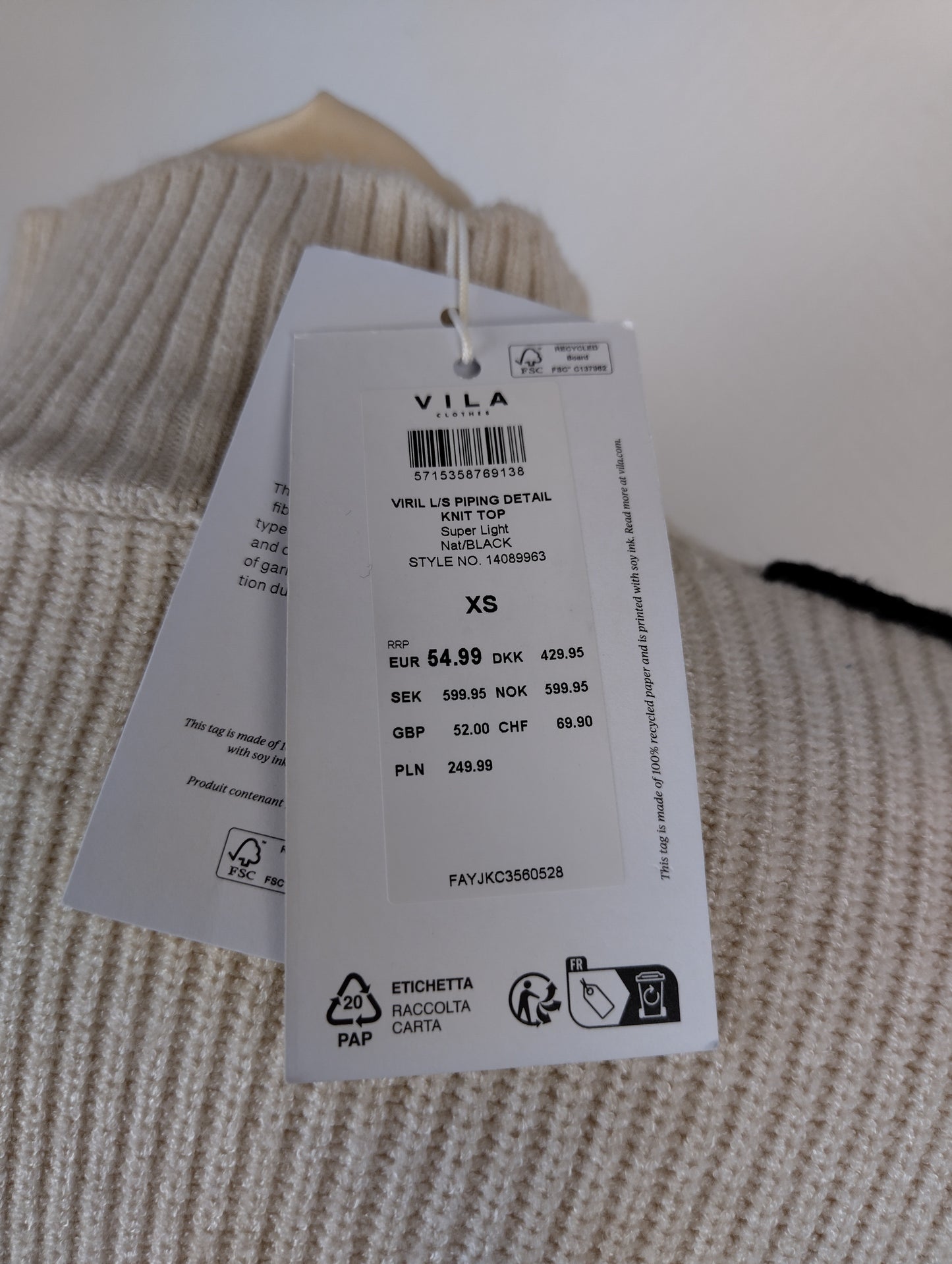 Close-up of Vila sweater tag details