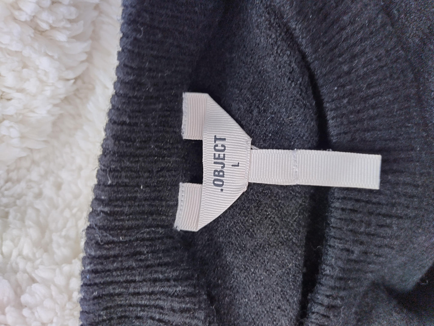 Close-up of Object tag on sweater