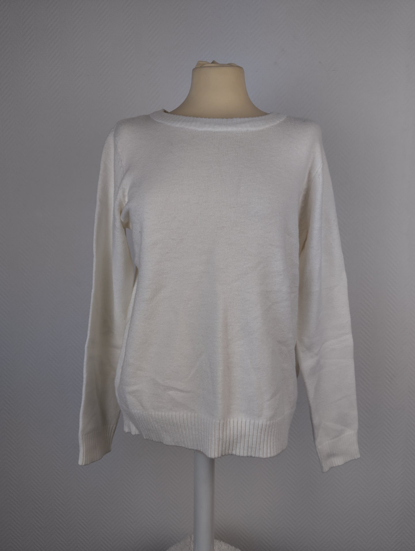 Front view of white knit sweater on a mannequin