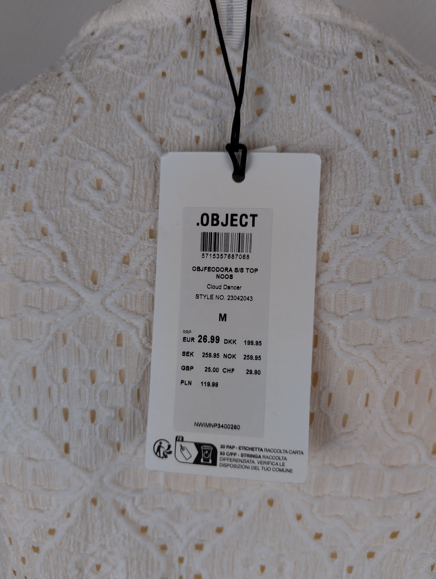 Close-up of tag on white lace top