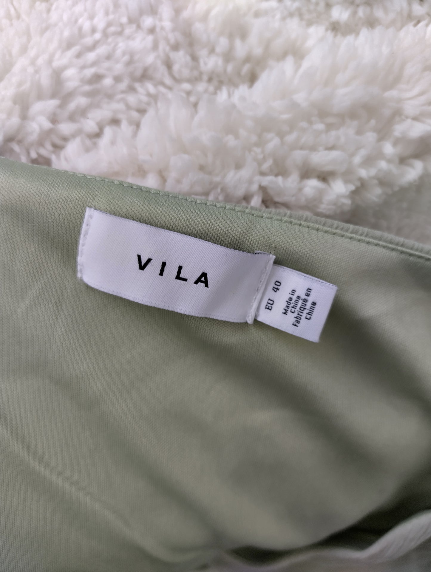 Vila brand tag on light green dress