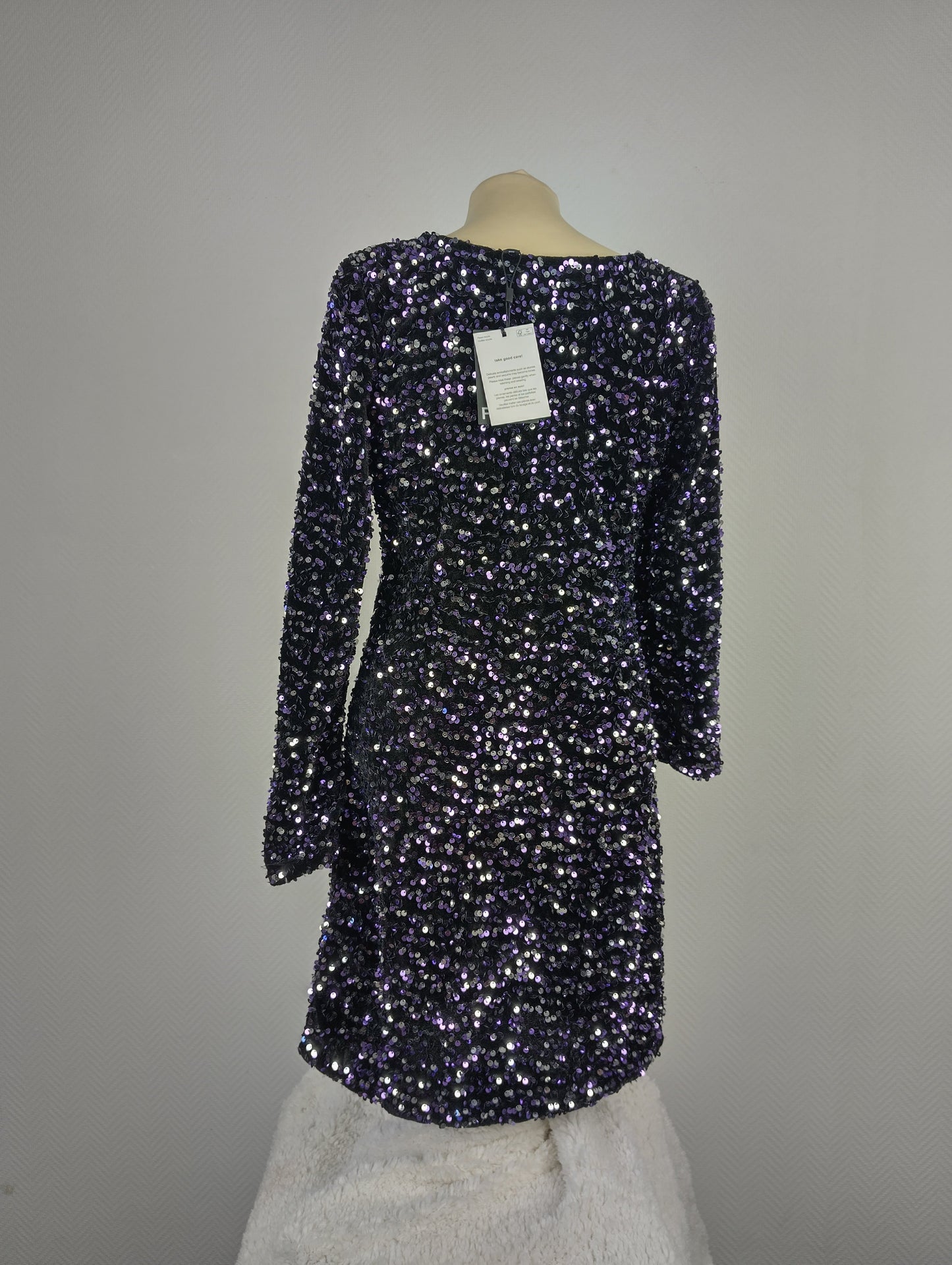 Back view of a black and purple sequined dress