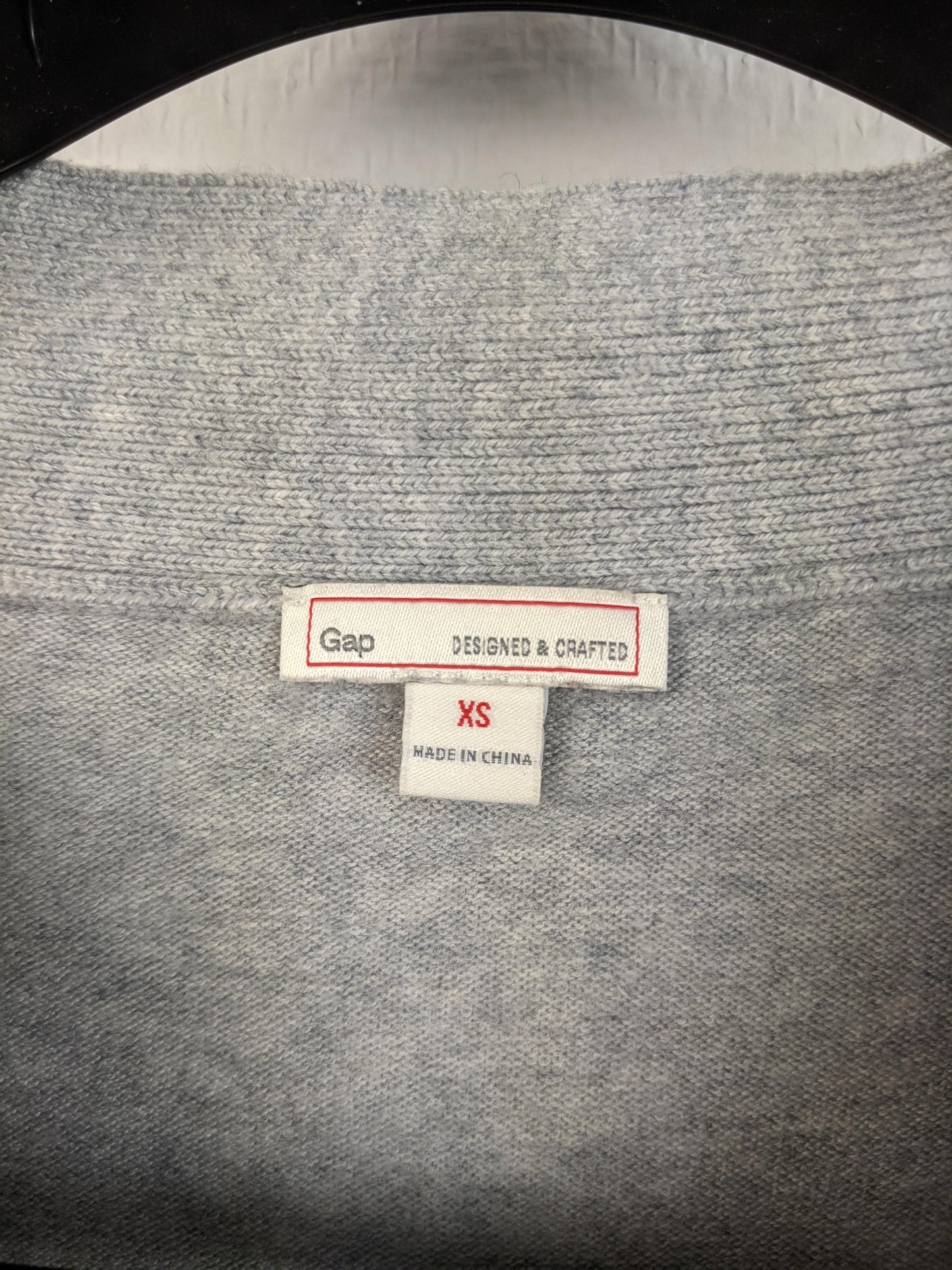 Close-up of Gap label and size tag showing XS