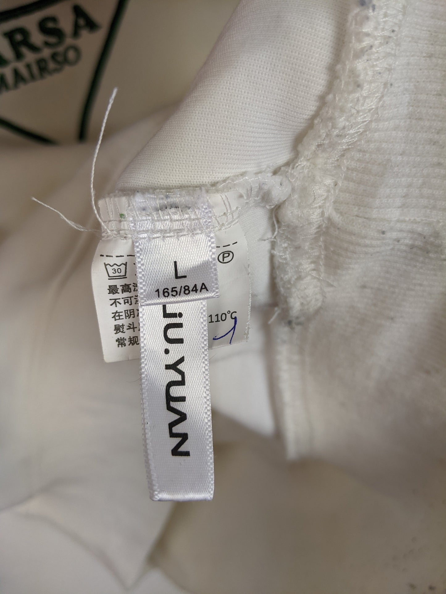 Tag showing size L and brand information