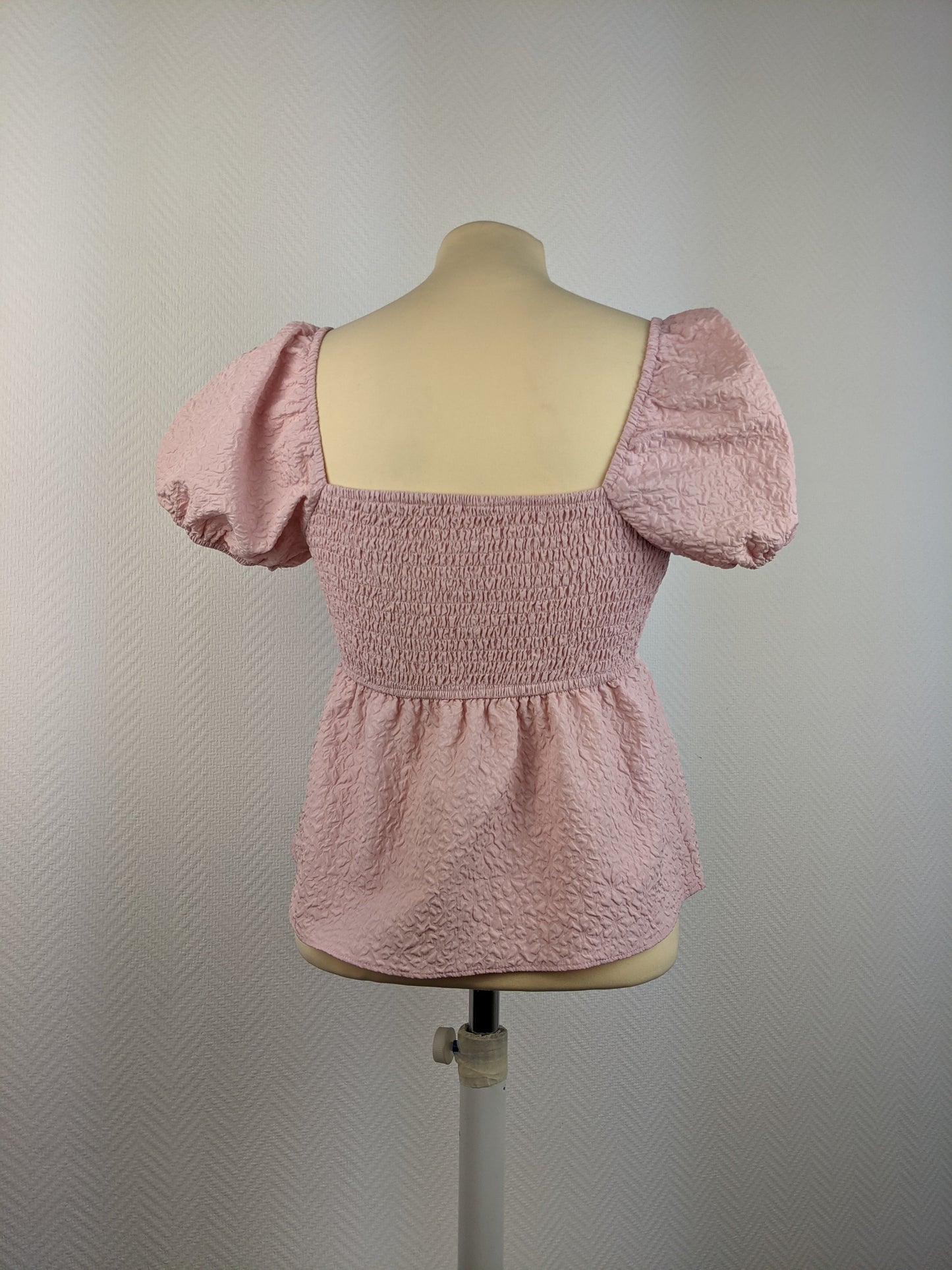 Back view of pink textured puff sleeve top