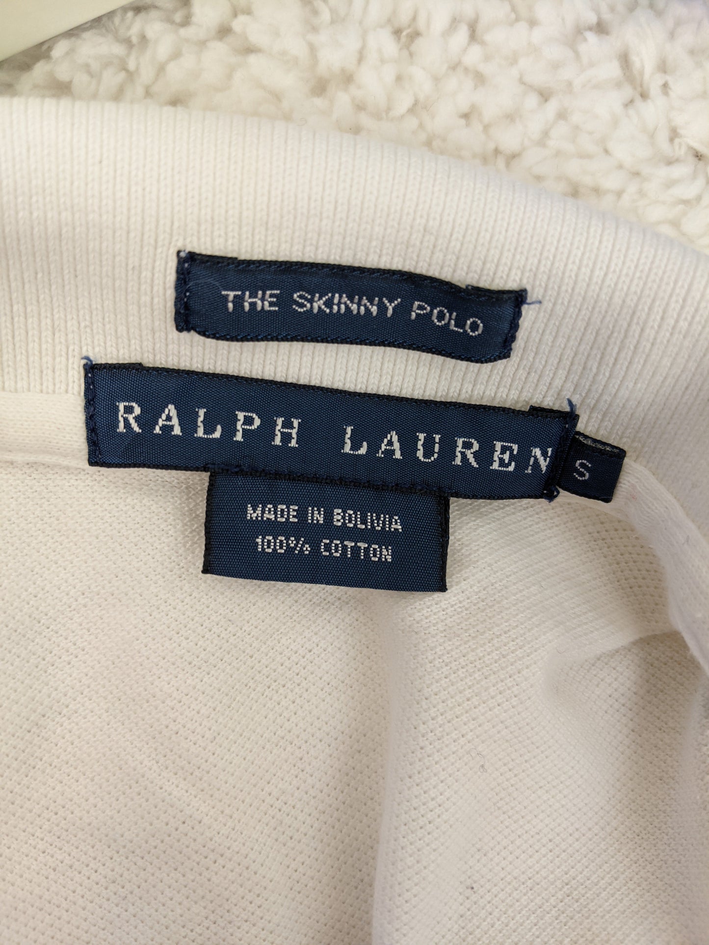 Label of Ralph Lauren white polo shirt showing material and origin