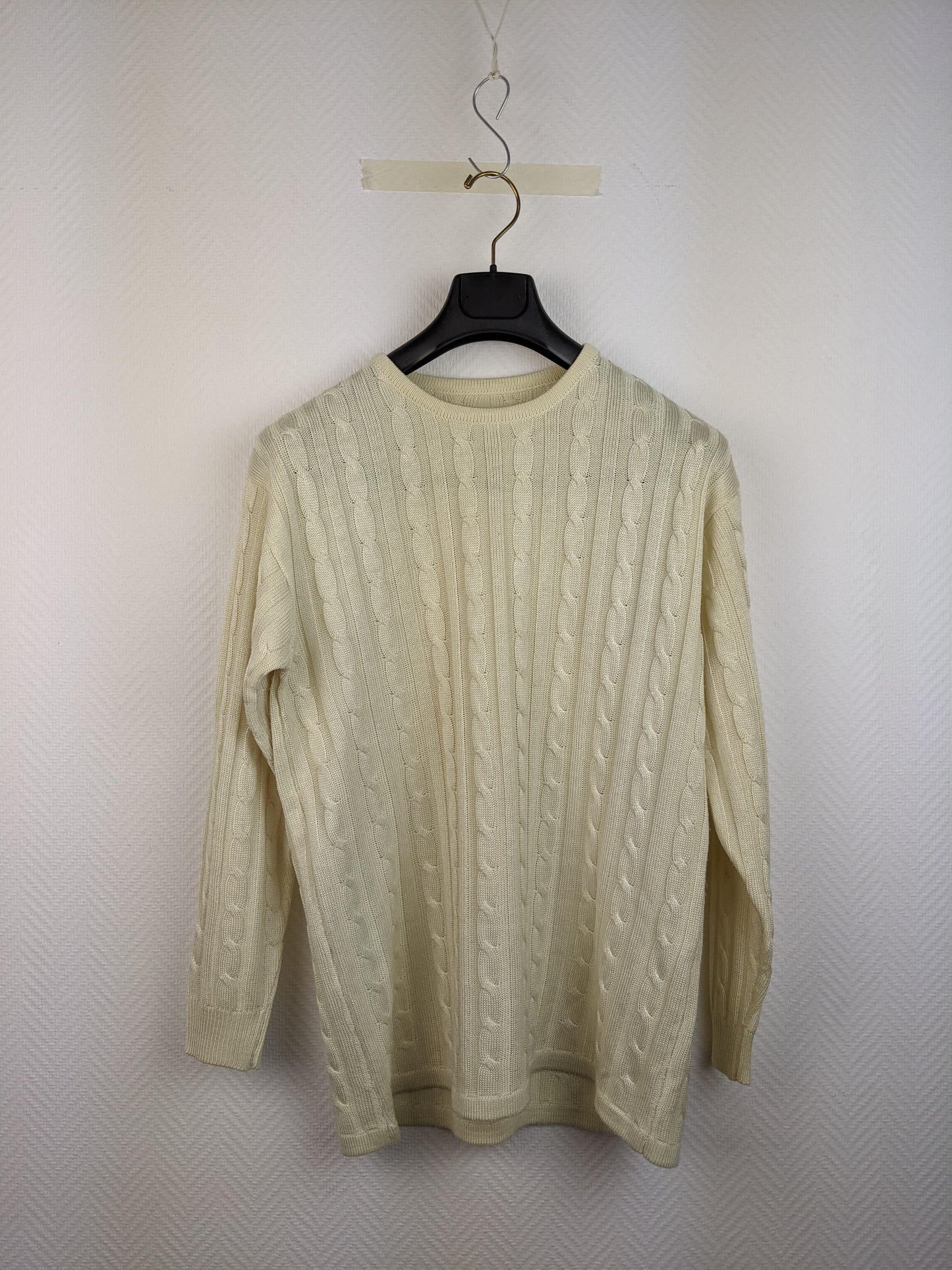 Front view of cream cable knit sweater