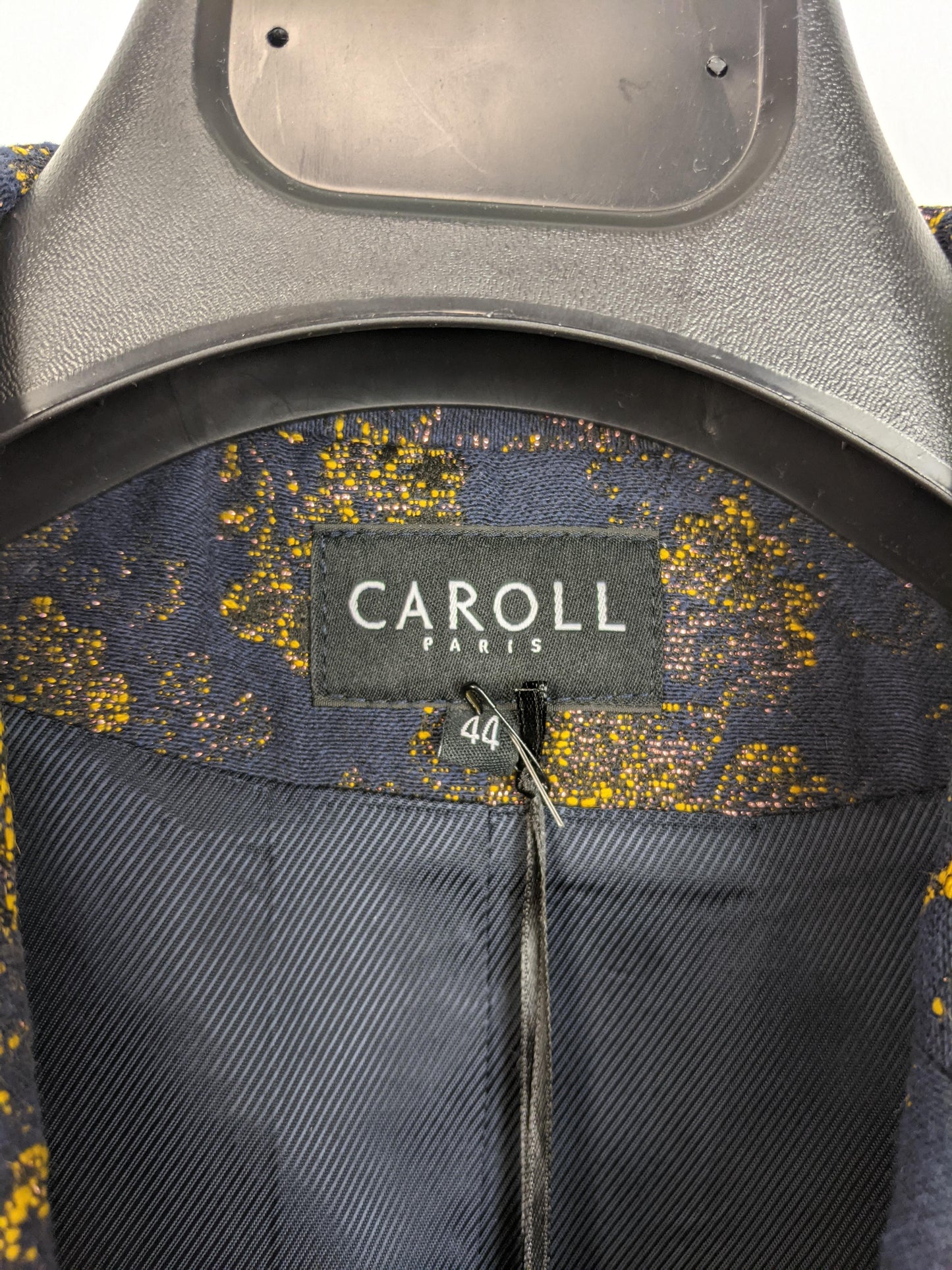 Close-up of Caroll brand label in blazer