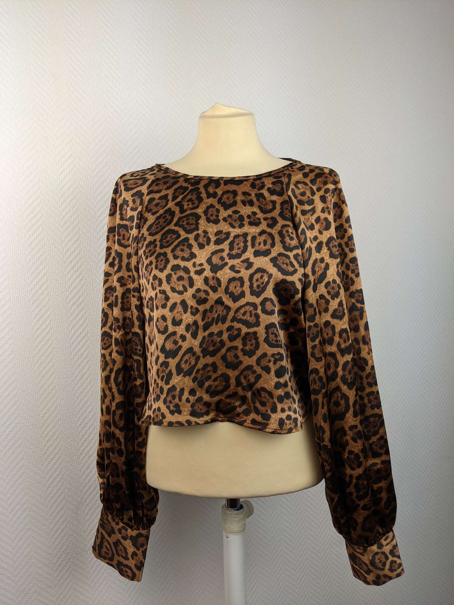 Front view of leopard print satin blouse on mannequin