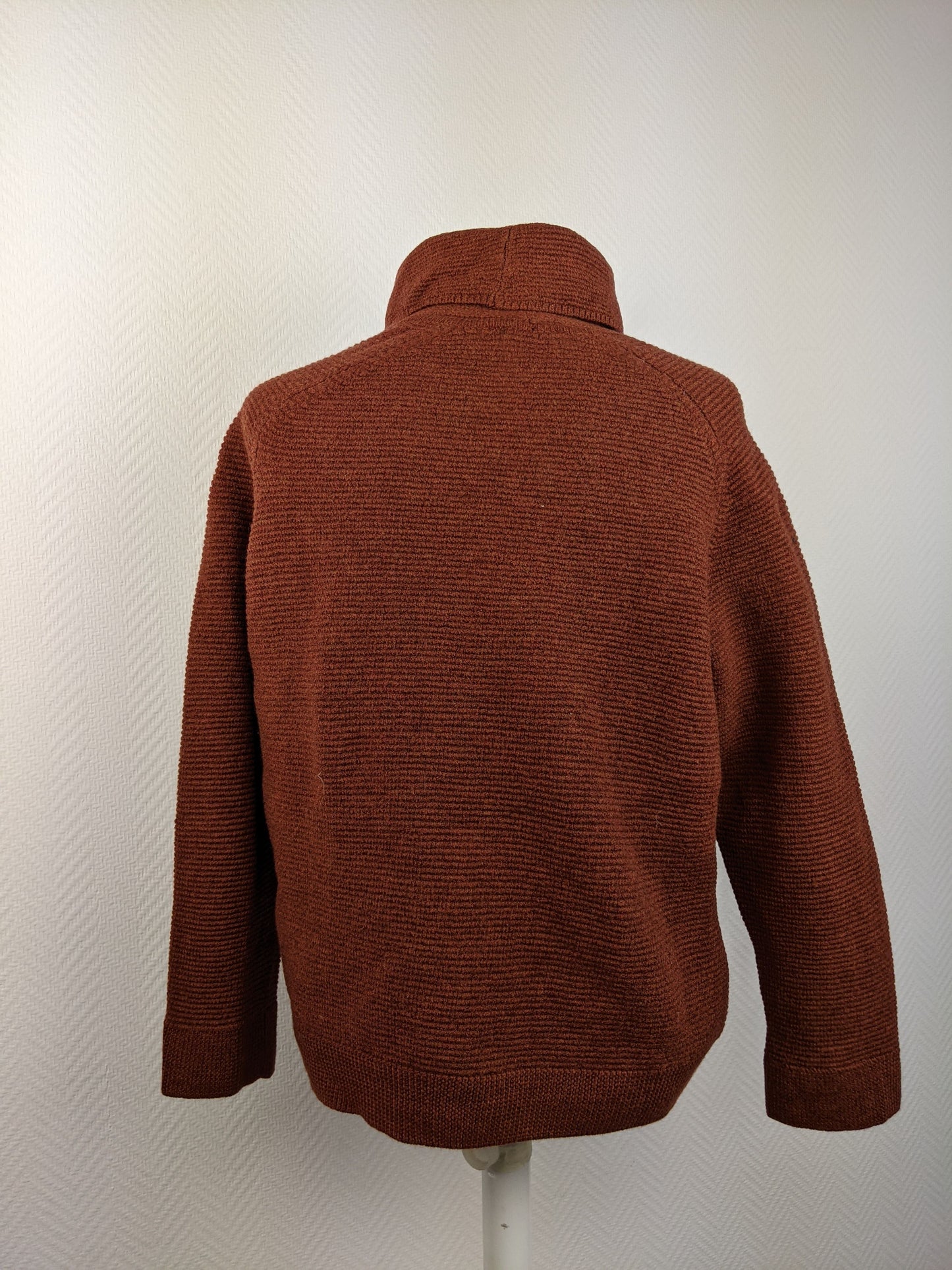 Back view of brown sweater on mannequin