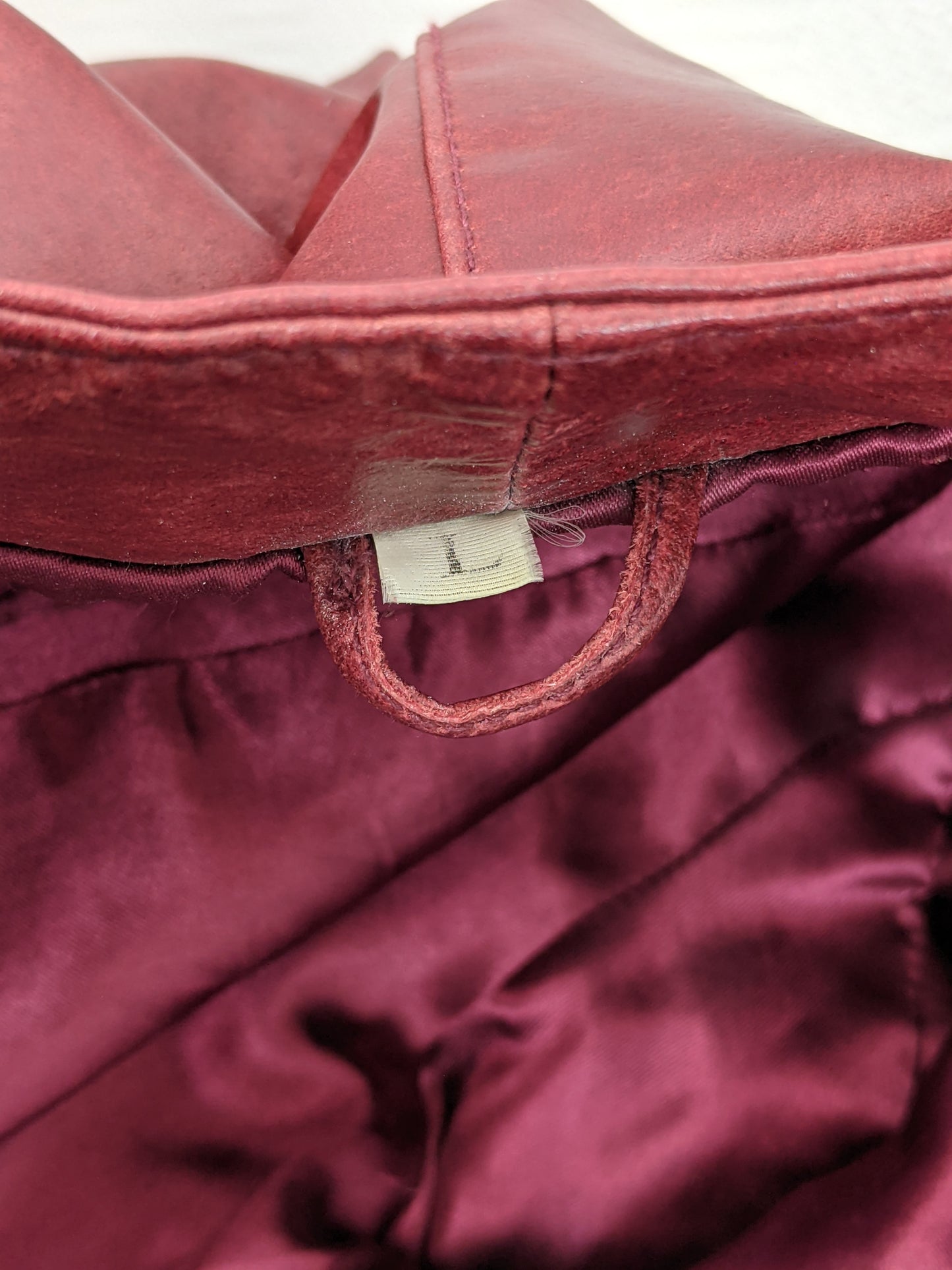 Inside collar of red leather jacket showing size