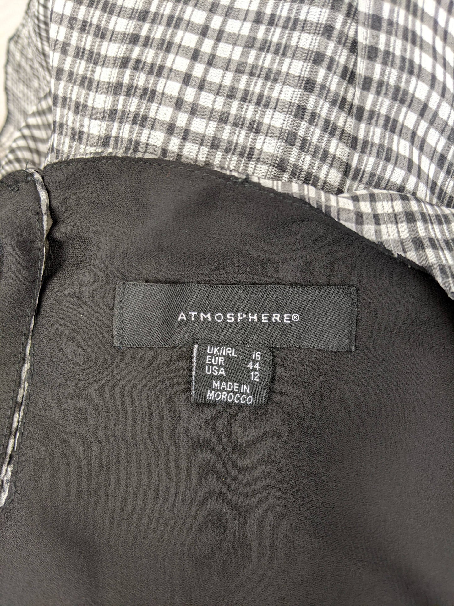 Close-up of Atmosphere brand label and size tag