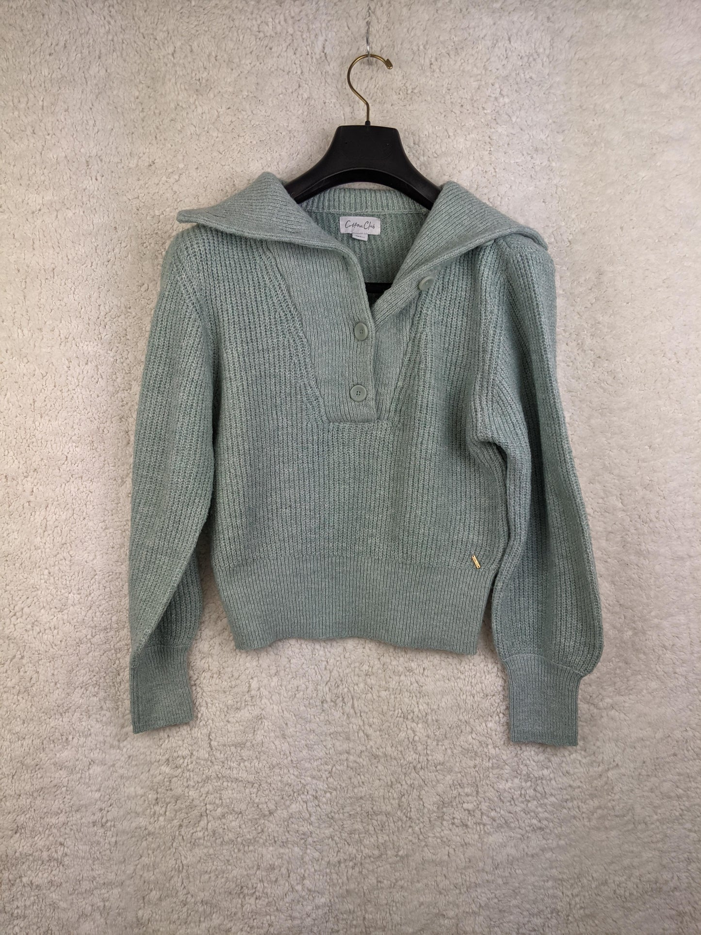 Front view of light green ribbed sweater