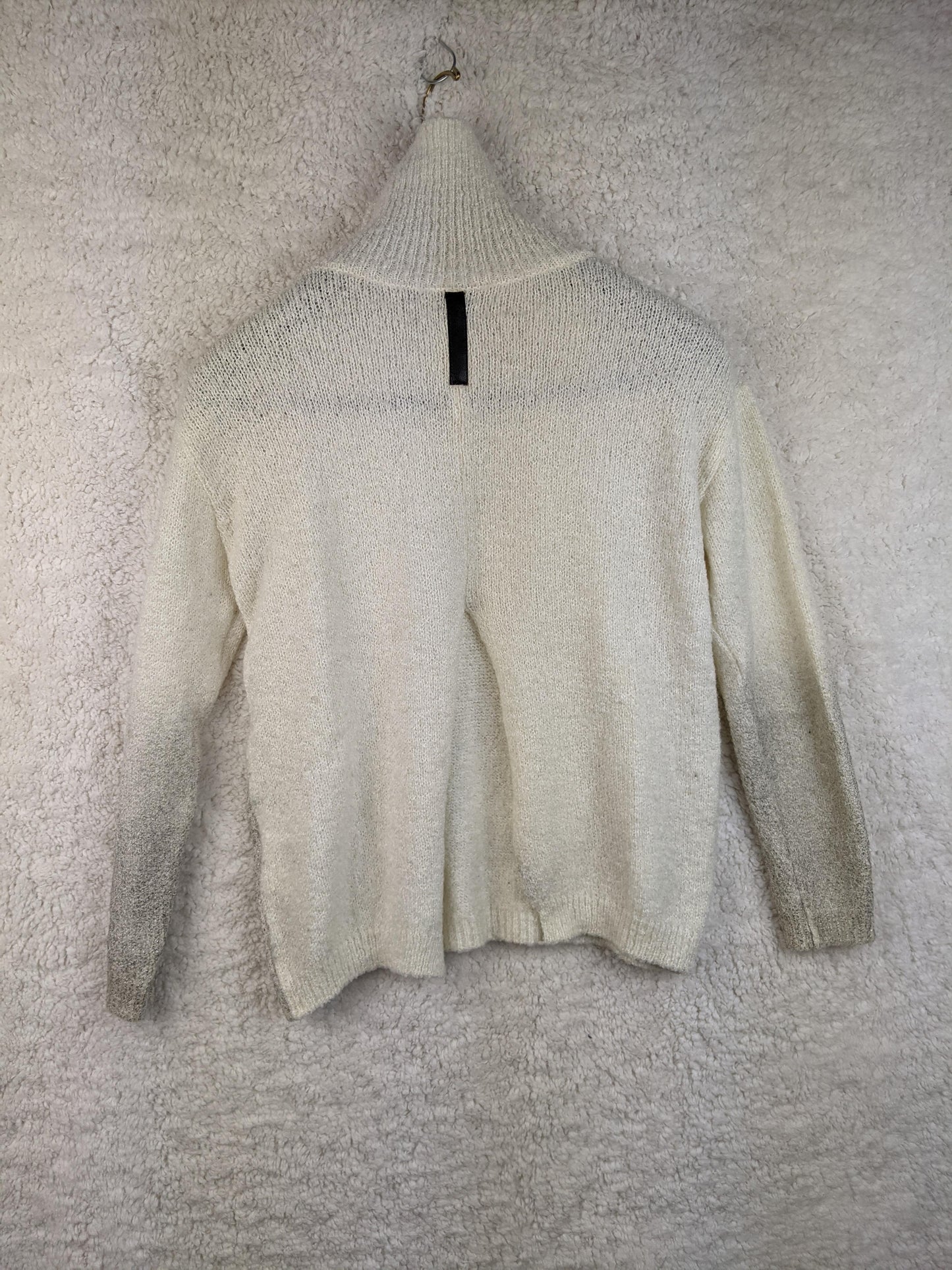 Back view of cream high neck sweater
