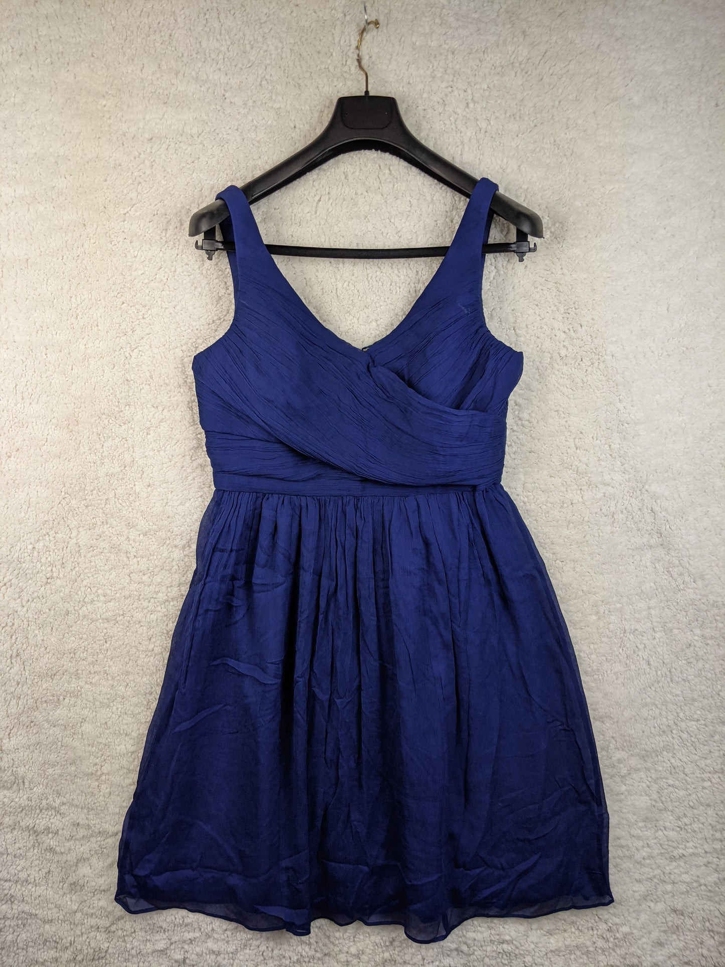 Front view of a blue sleeveless dress on hanger