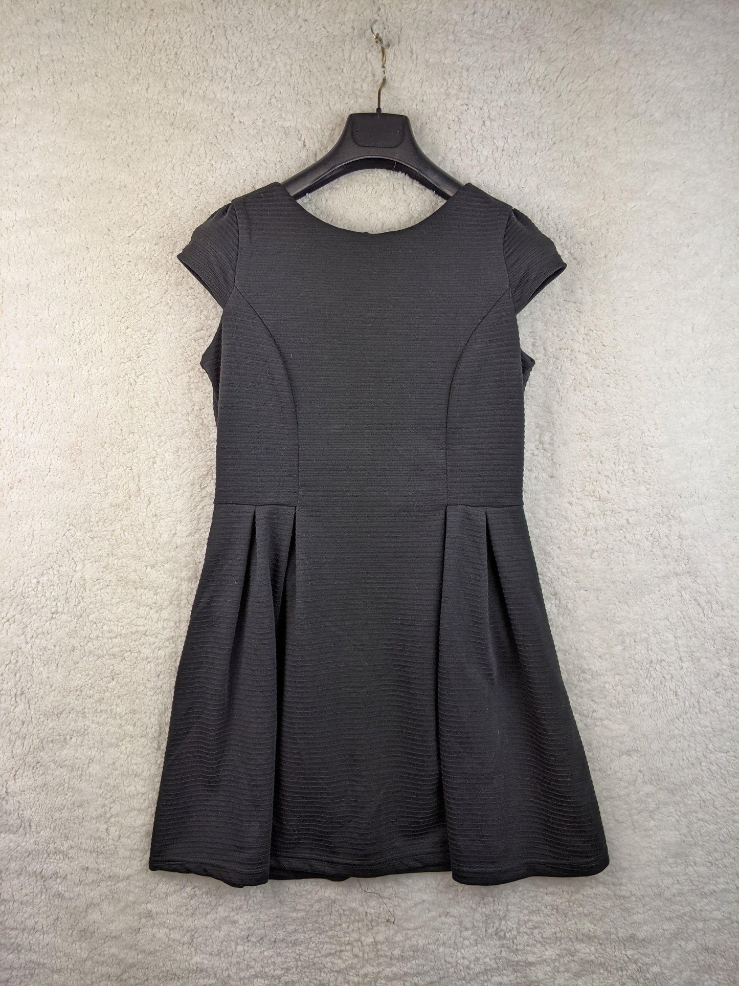 Front view of black dress on hanger