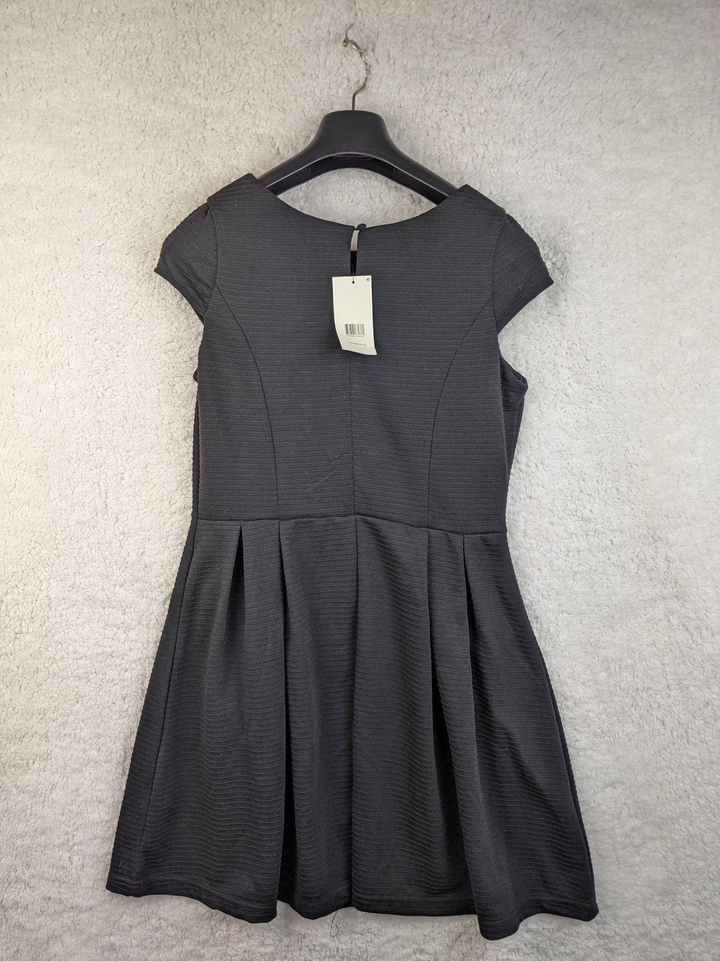 Back view of black dress on hanger