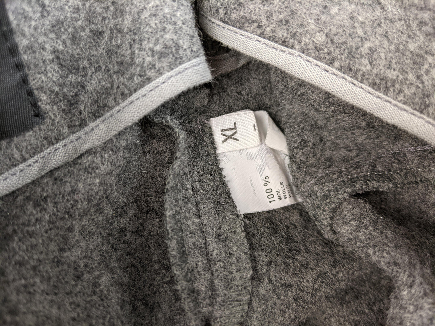 Size tag showing XL and 100% wool composition