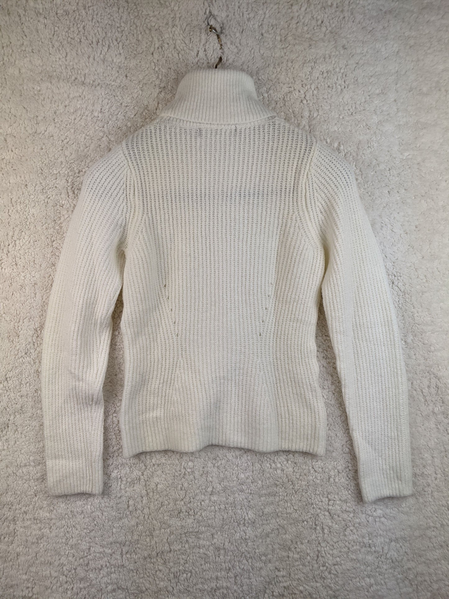 Back view of white ribbed turtleneck sweater