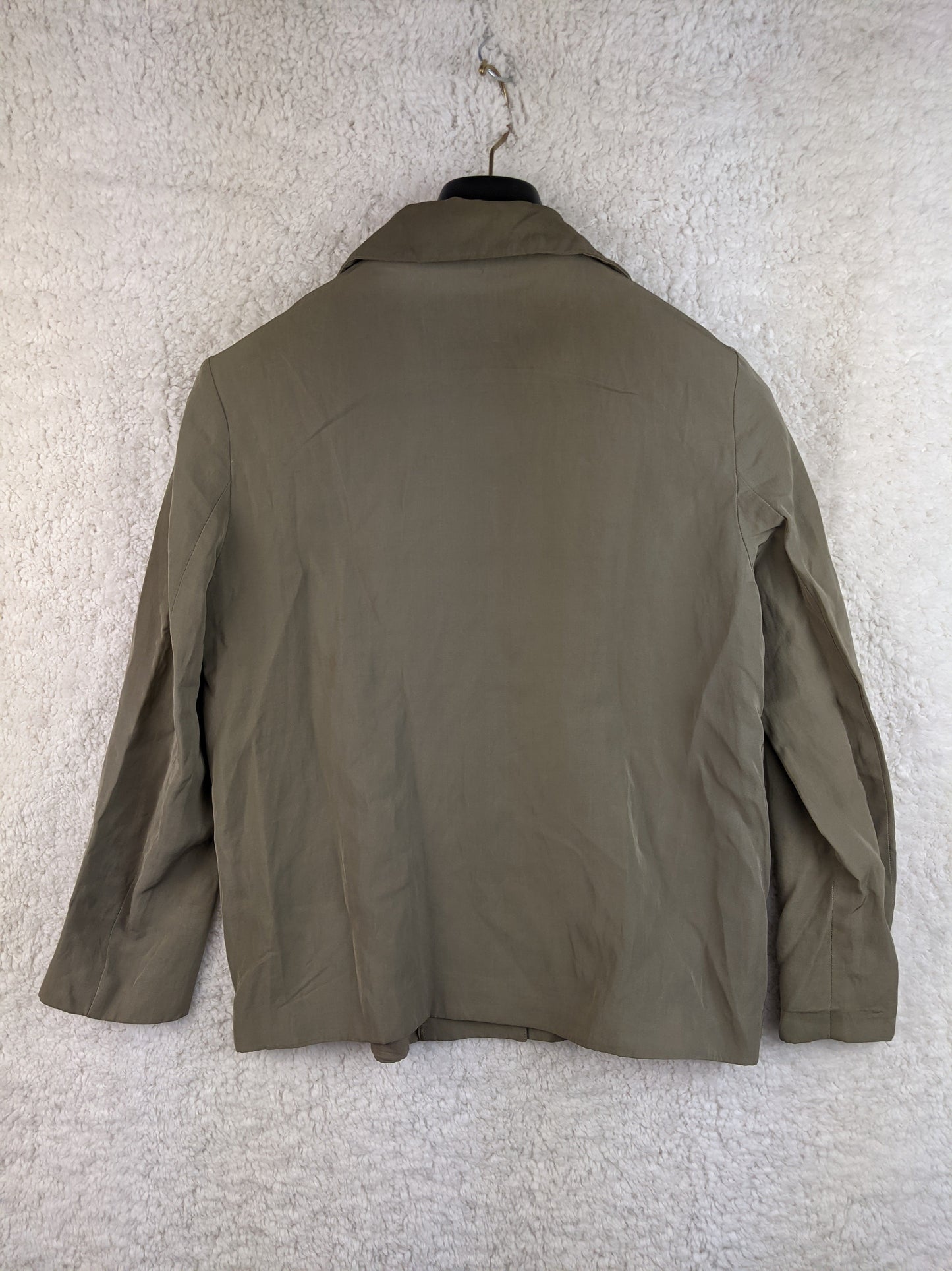 Back view of olive green jacket on hanger