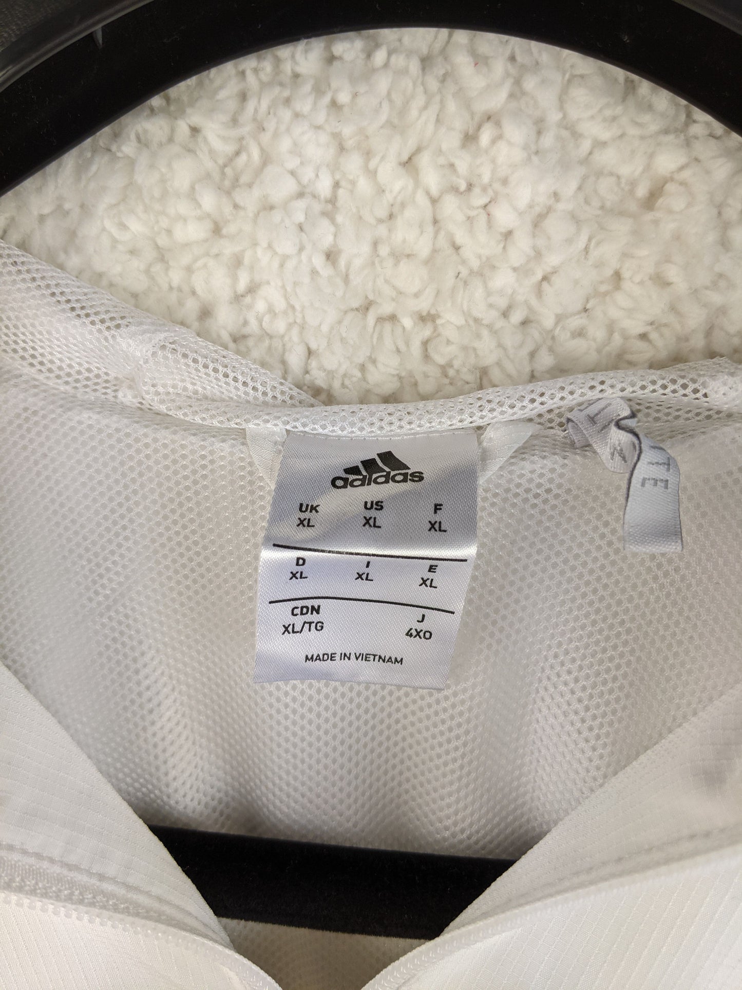 Size tag of Adidas AC Milan jacket showing XL