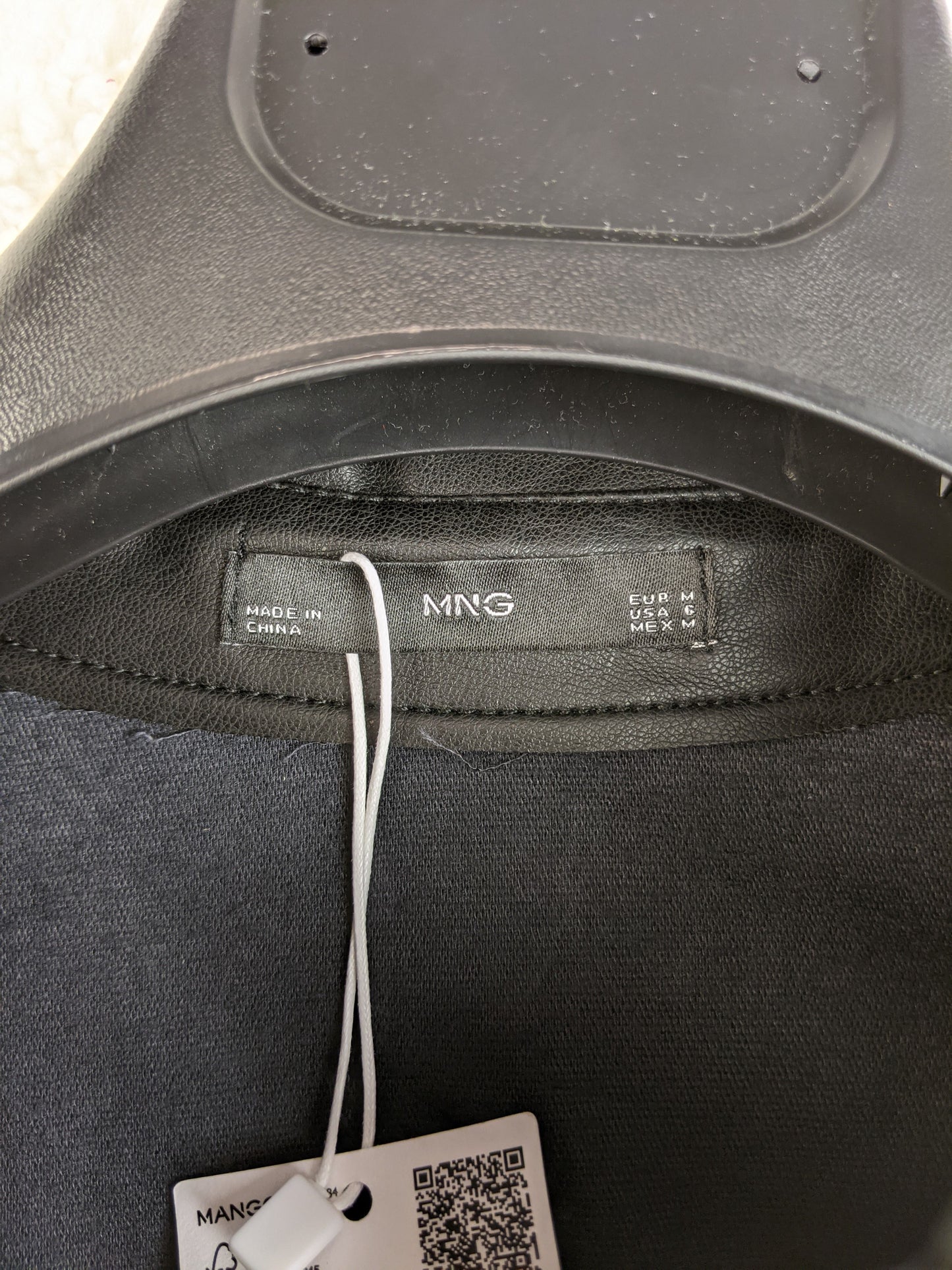 Label of Mango black faux leather shirt showing size M