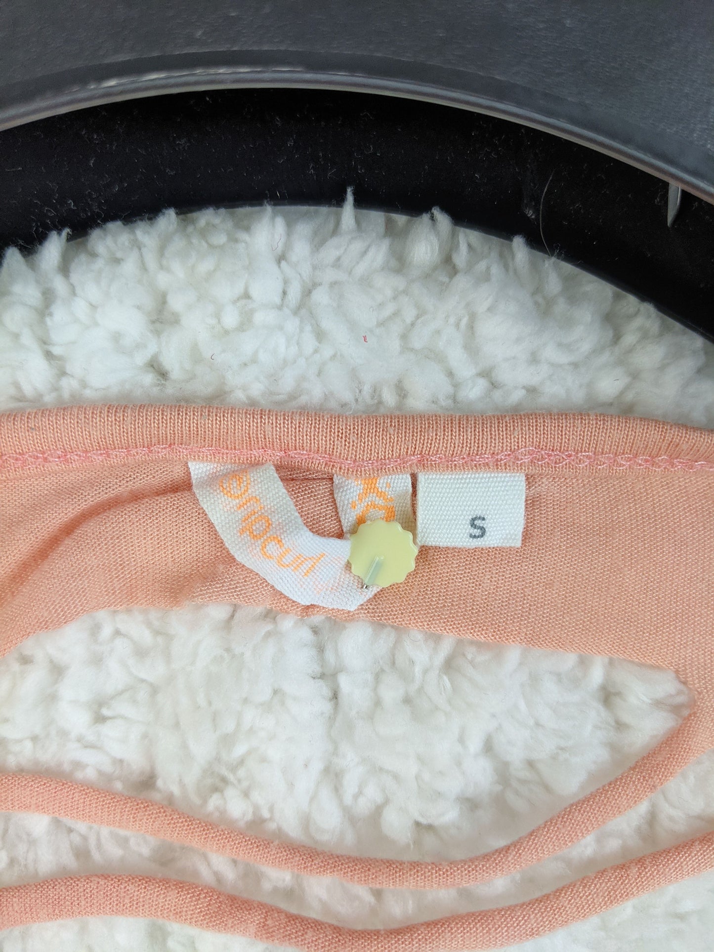 Rip Curl size tag on peach tank top