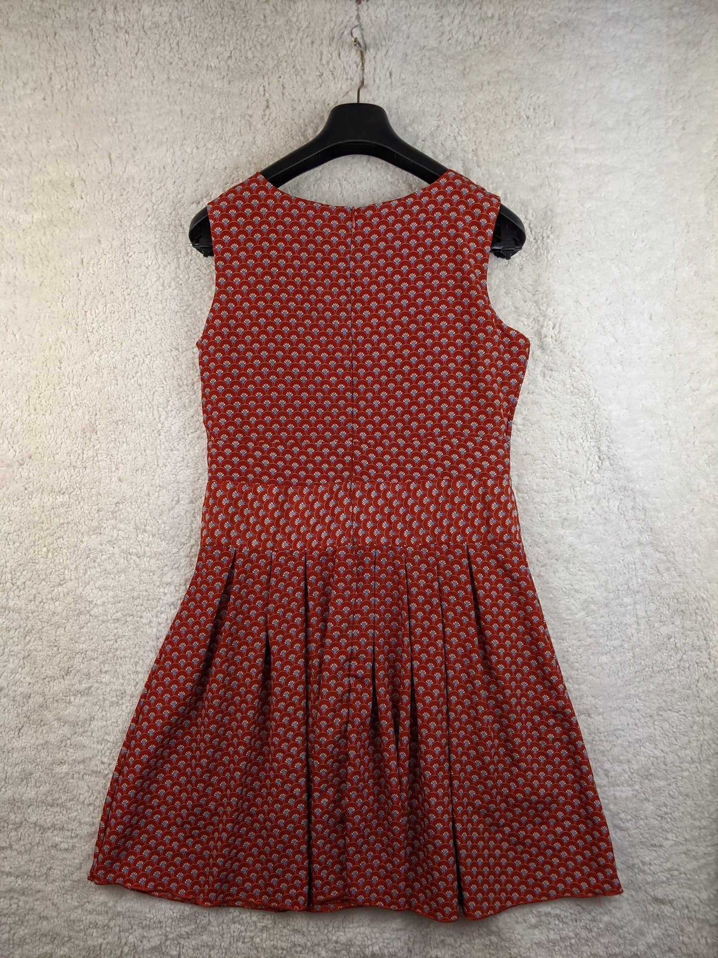 Back view of red patterned dress on hanger