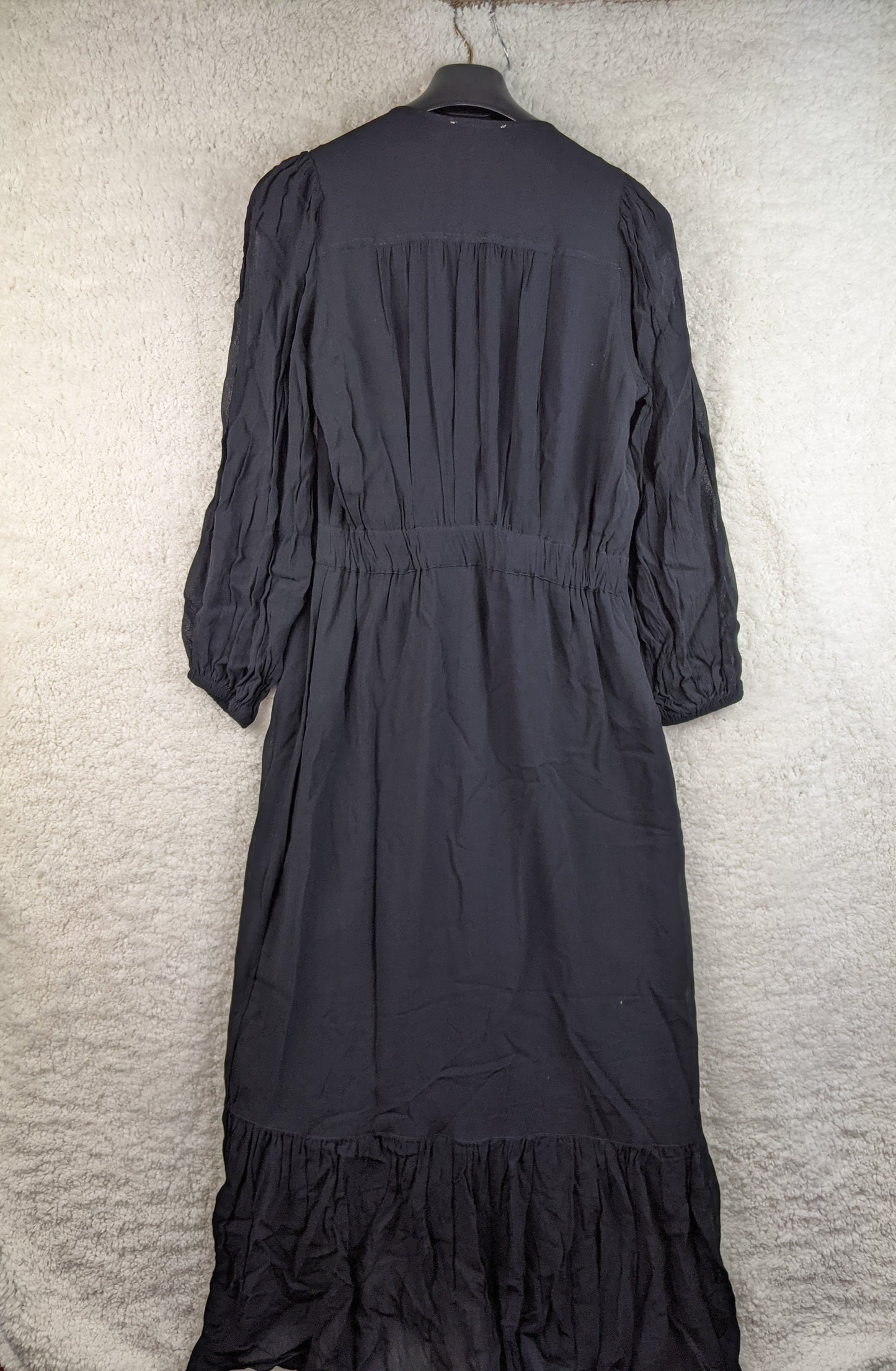 Back view of black ruffled long dress