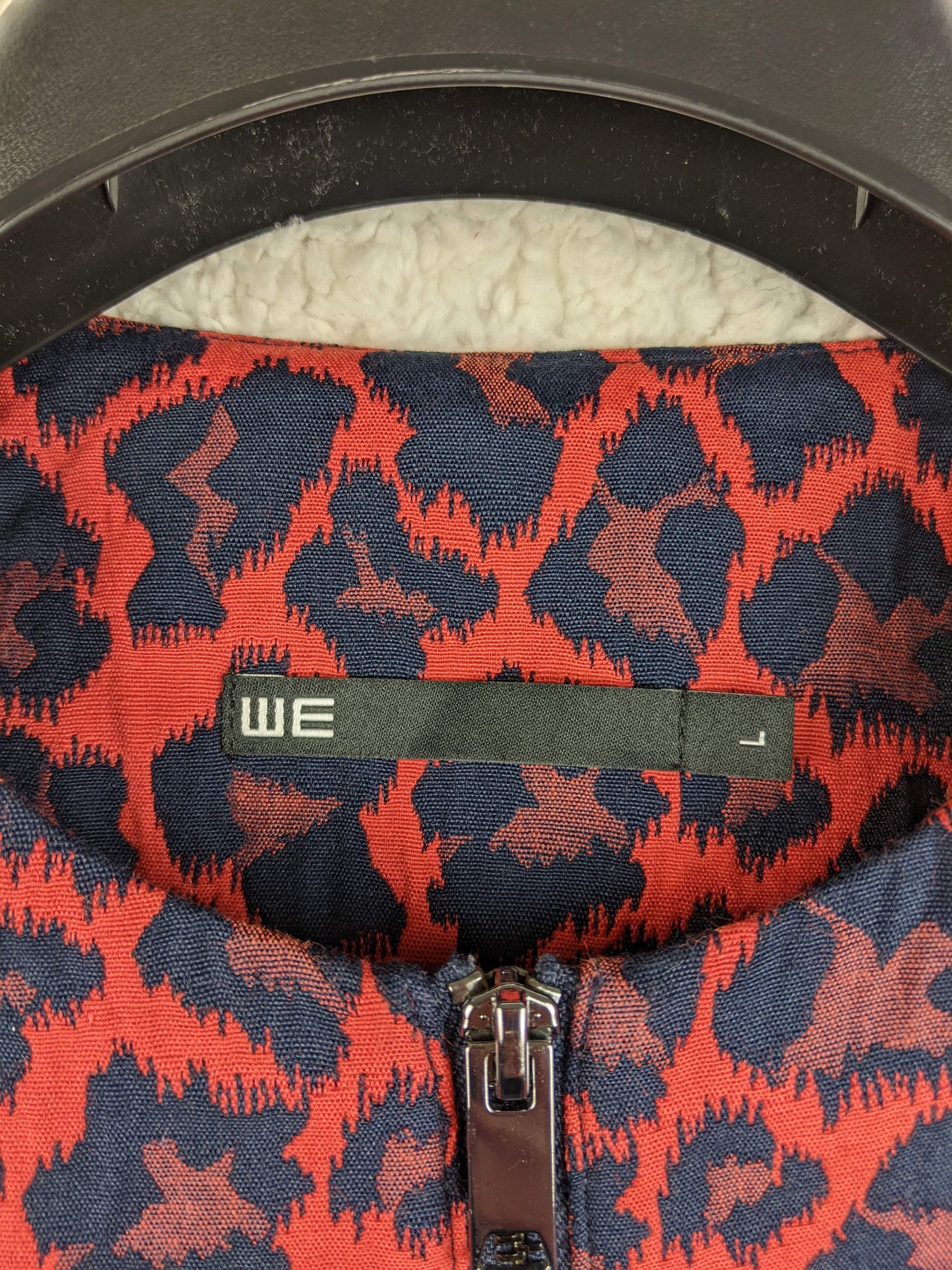 Close-up of label on WE red and black leopard print coat