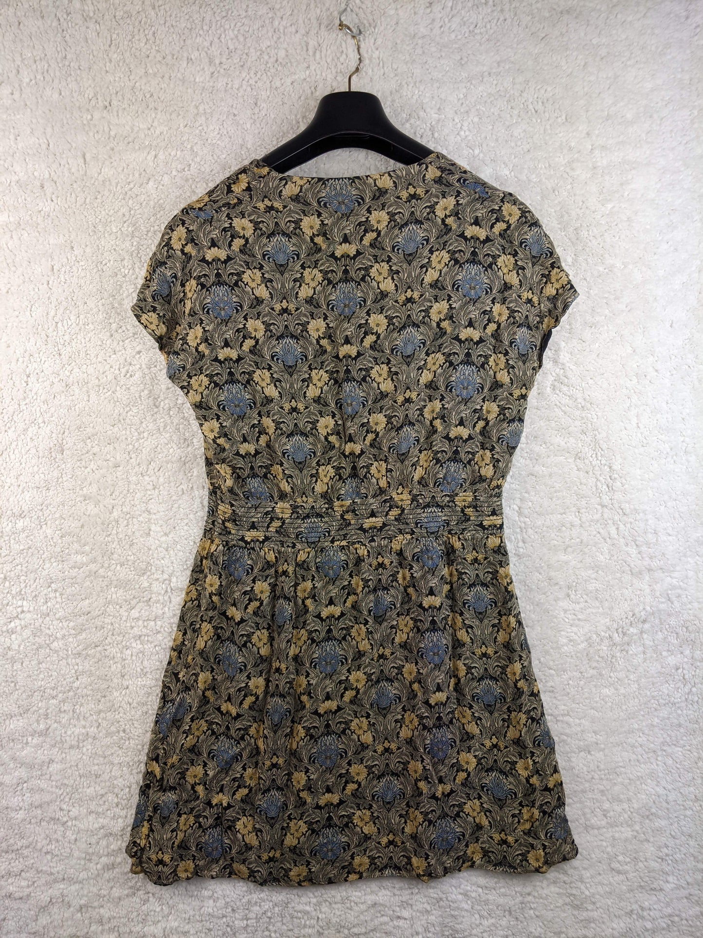 Back view of the vintage-style dress on a hanger