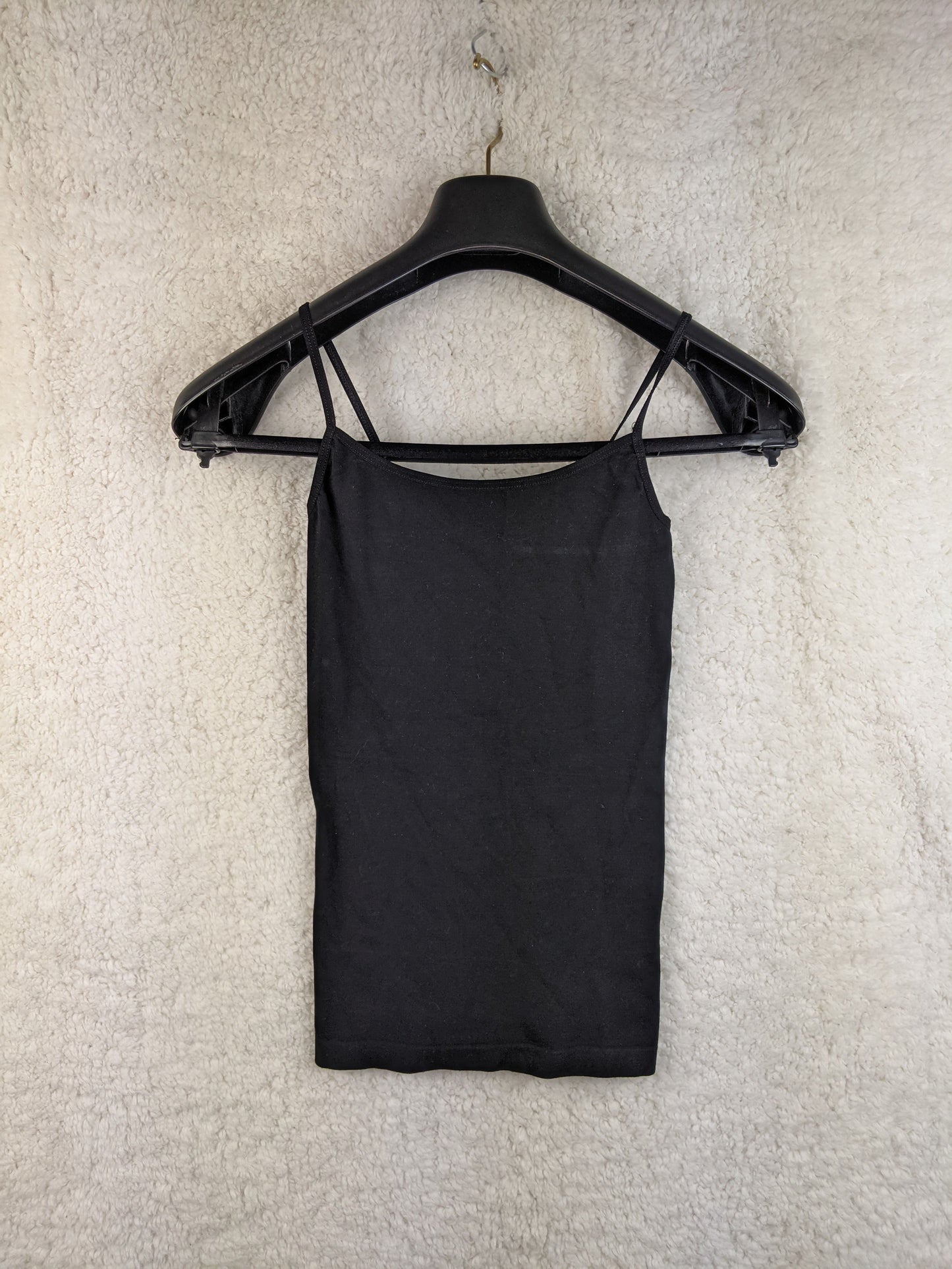 Black spaghetti strap top on hanger