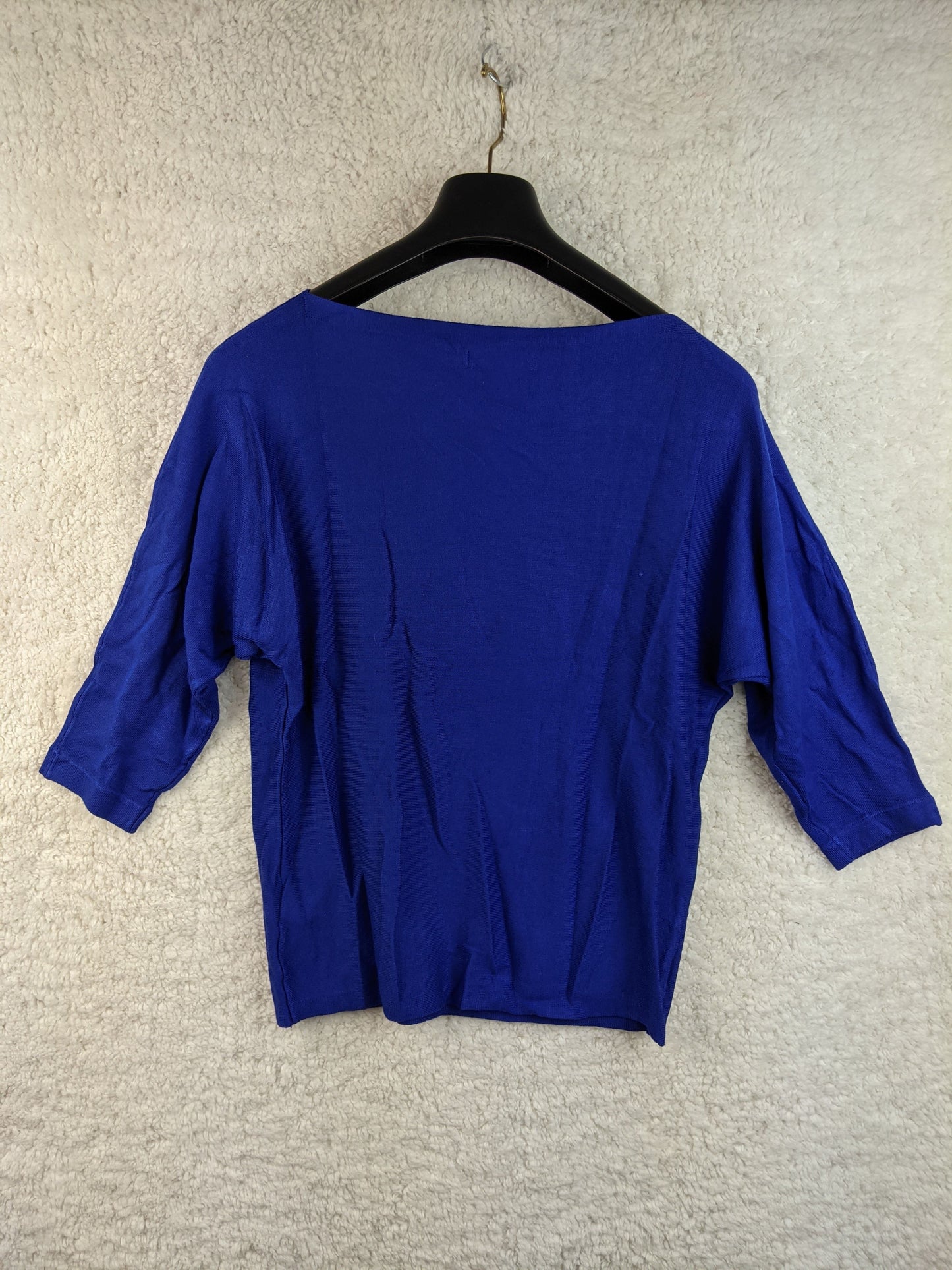 Back view of blue long sleeve top