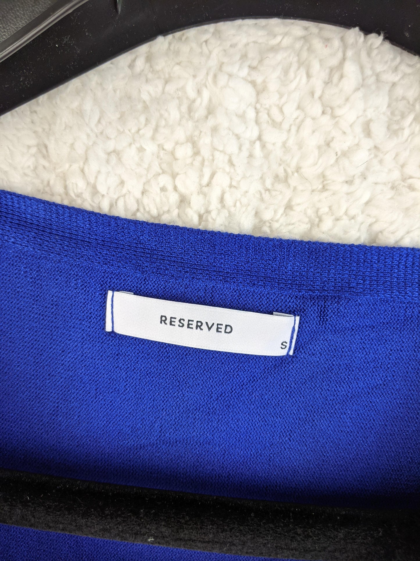Brand label of Reserved in blue top
