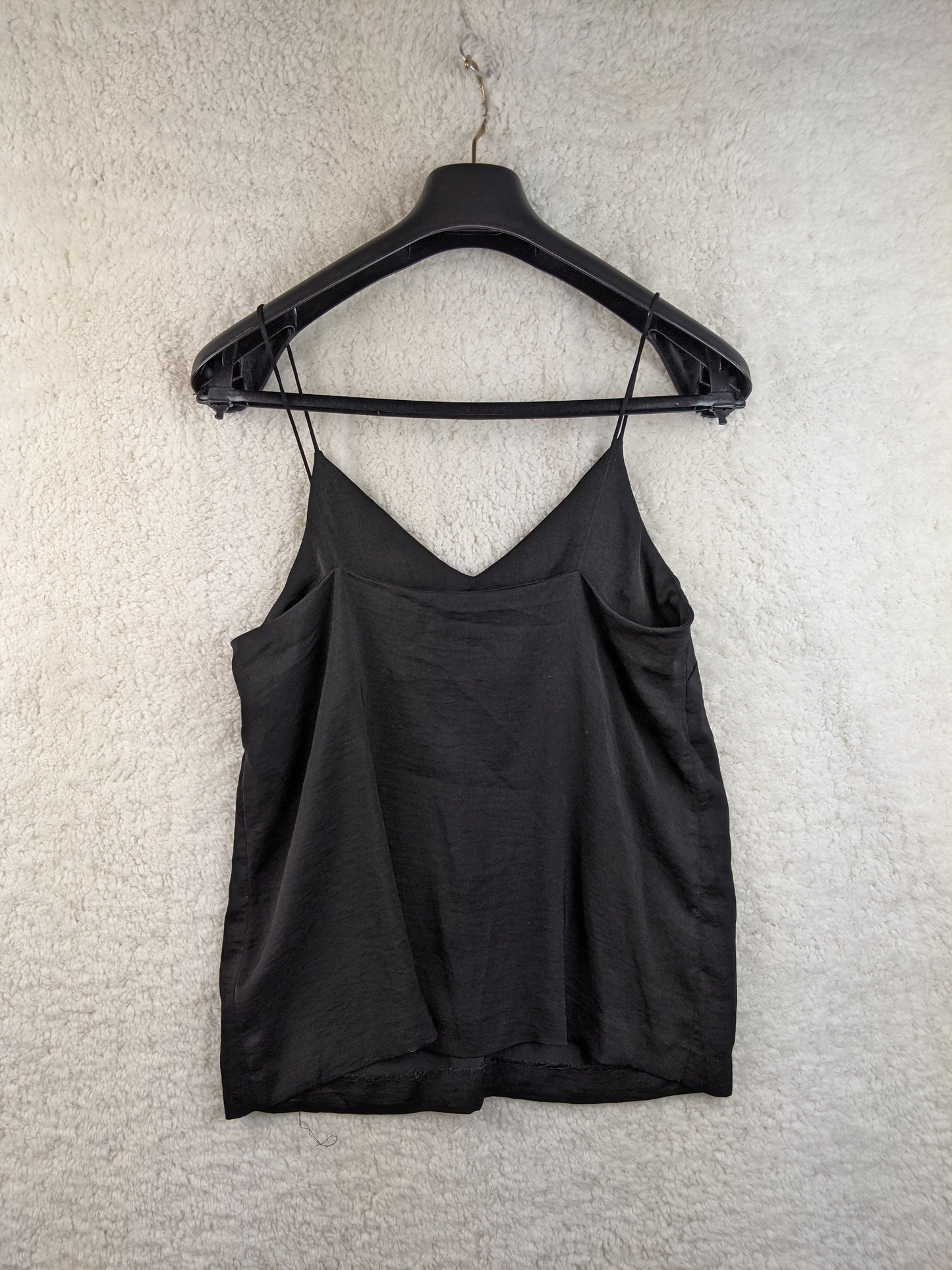 Back view of black camisole top on hanger