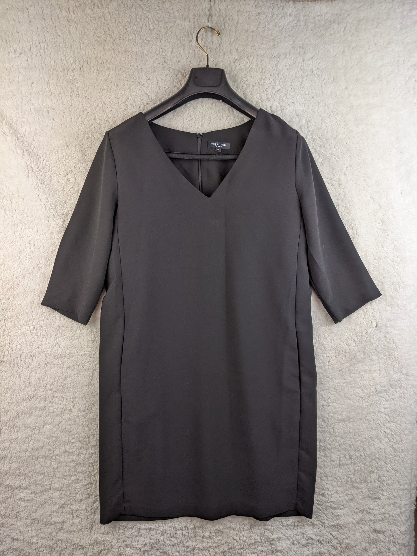 Front view of black dress on hanger