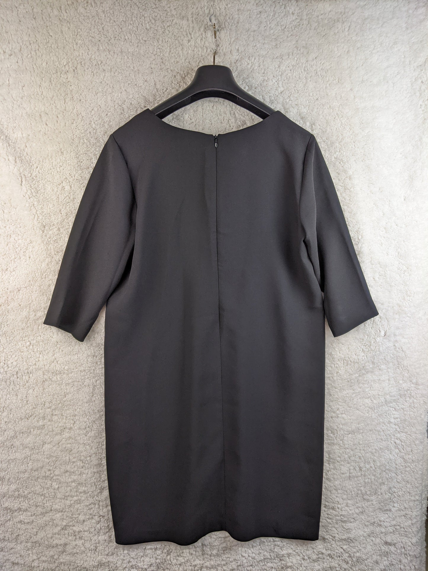 Back view of black dress on hanger